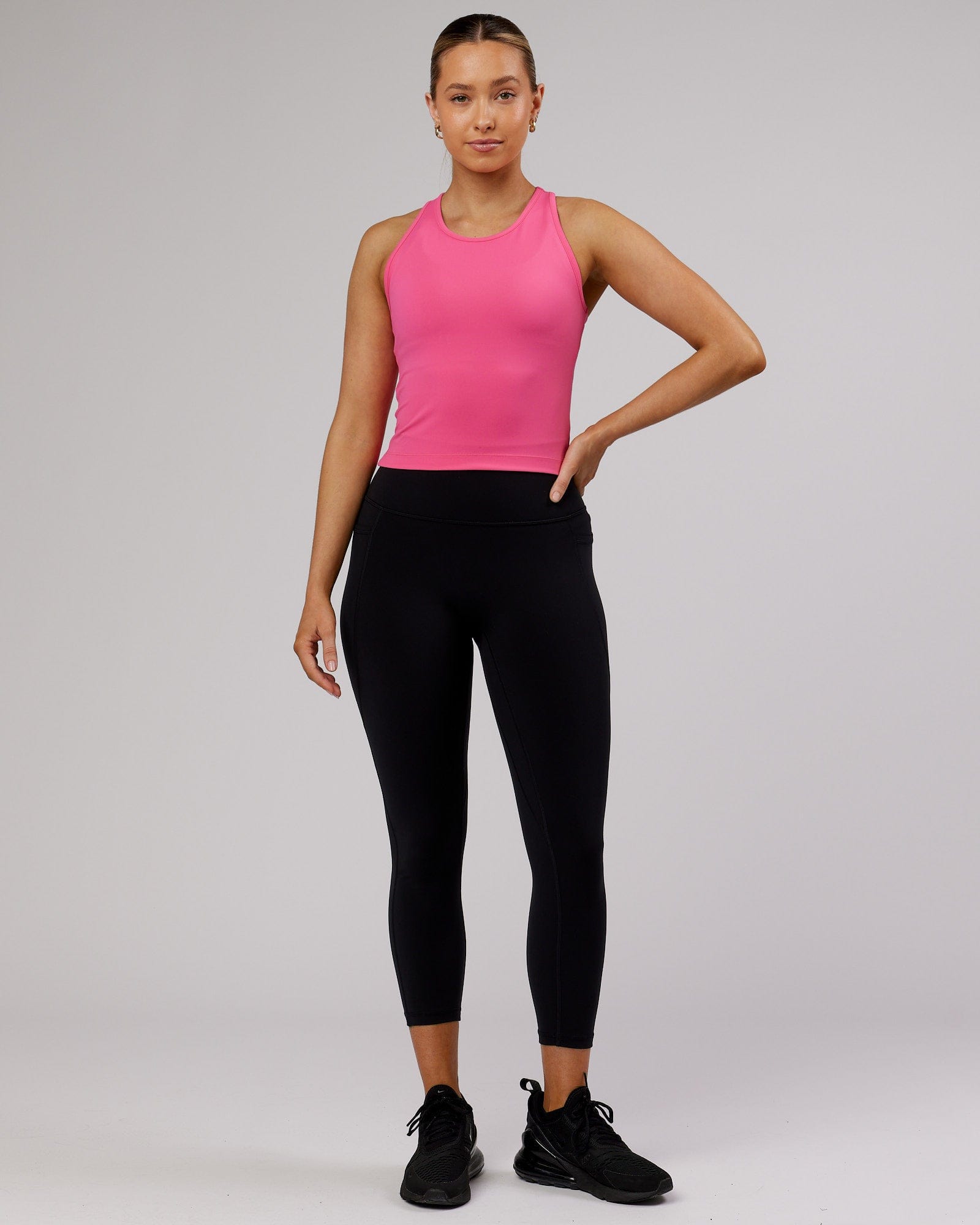 Model wearing Flow Performance Tank - Flamingo