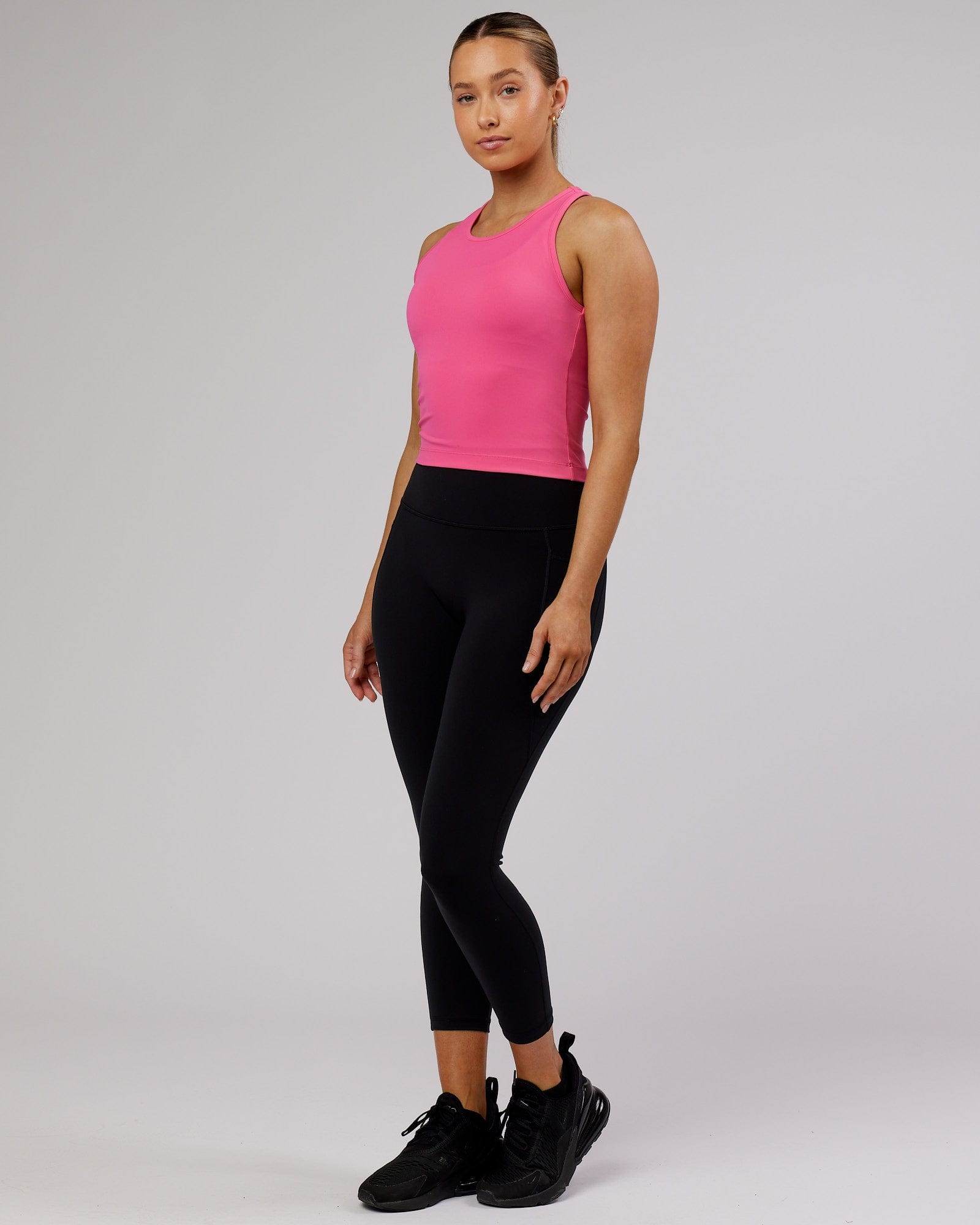 Model wearing Flow Performance Tank - Flamingo