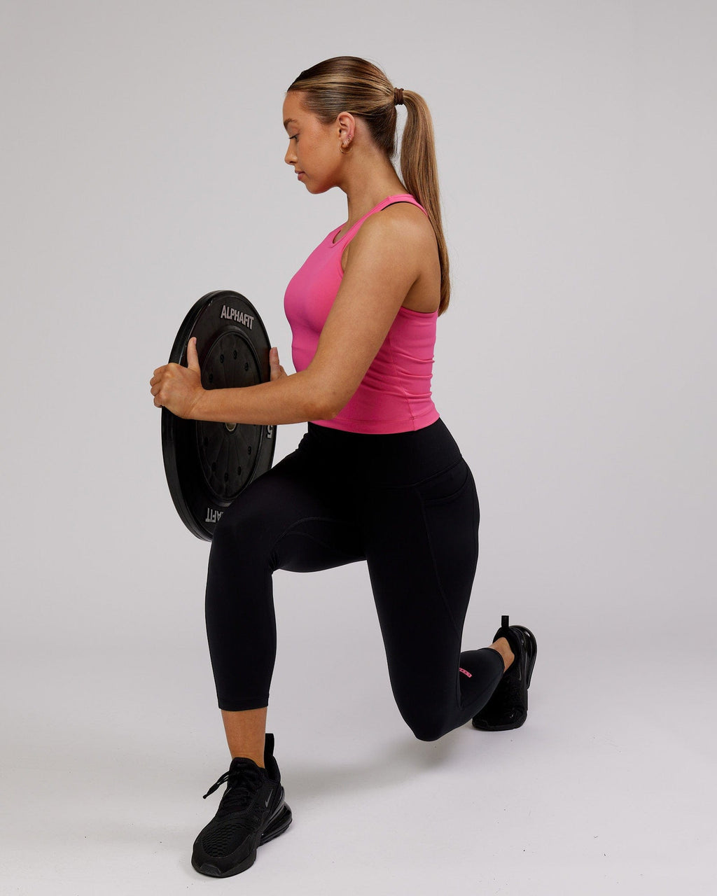 Model wearing Flow Performance Tank - Flamingo