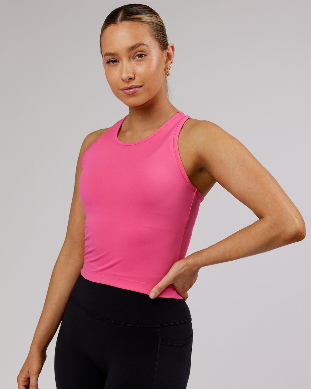 Model wearing Flow Performance Tank - Flamingo