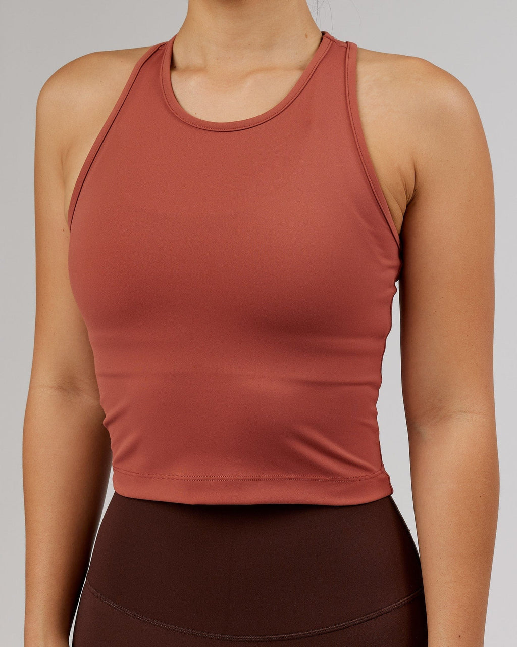 Model wearing Flow Performance Tank - Marsala