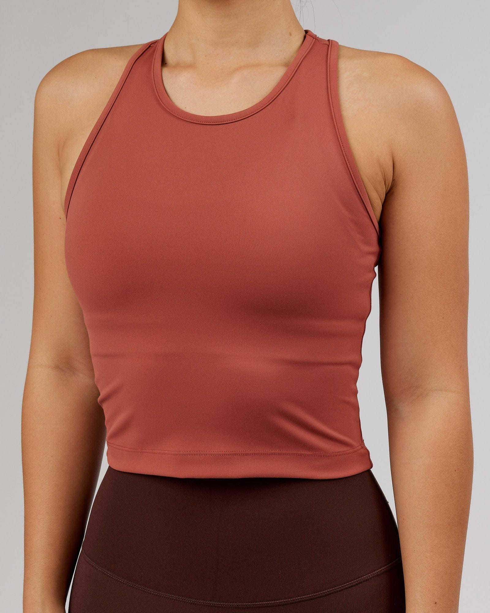 Model wearing Flow Performance Tank - Marsala
