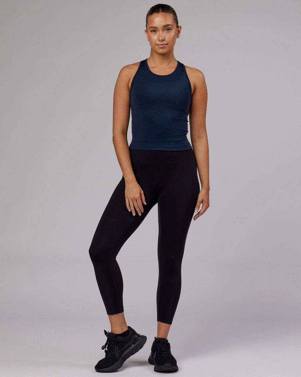 Model wearing Flow Performance Tank - Navy