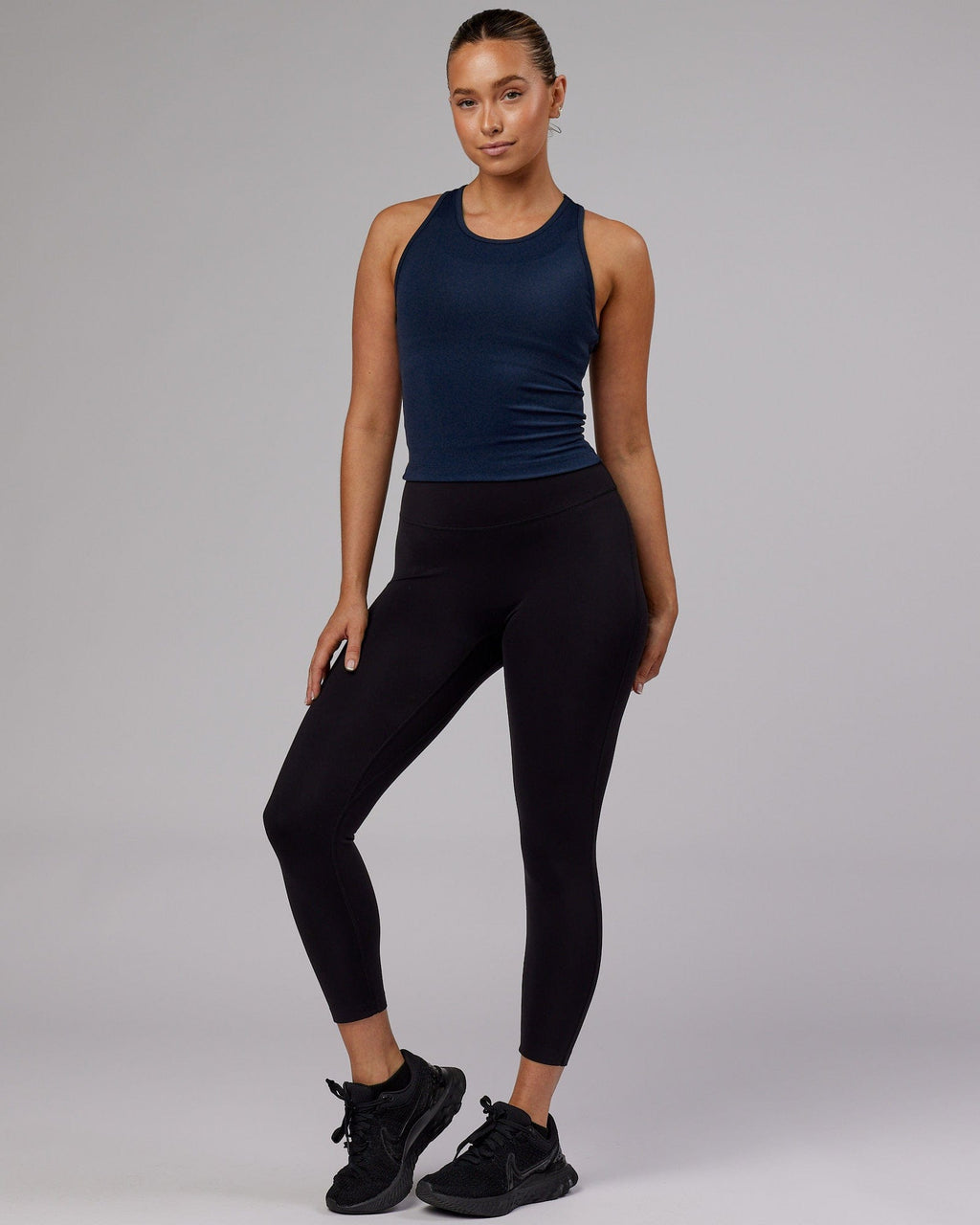Model wearing Flow Performance Tank - Navy