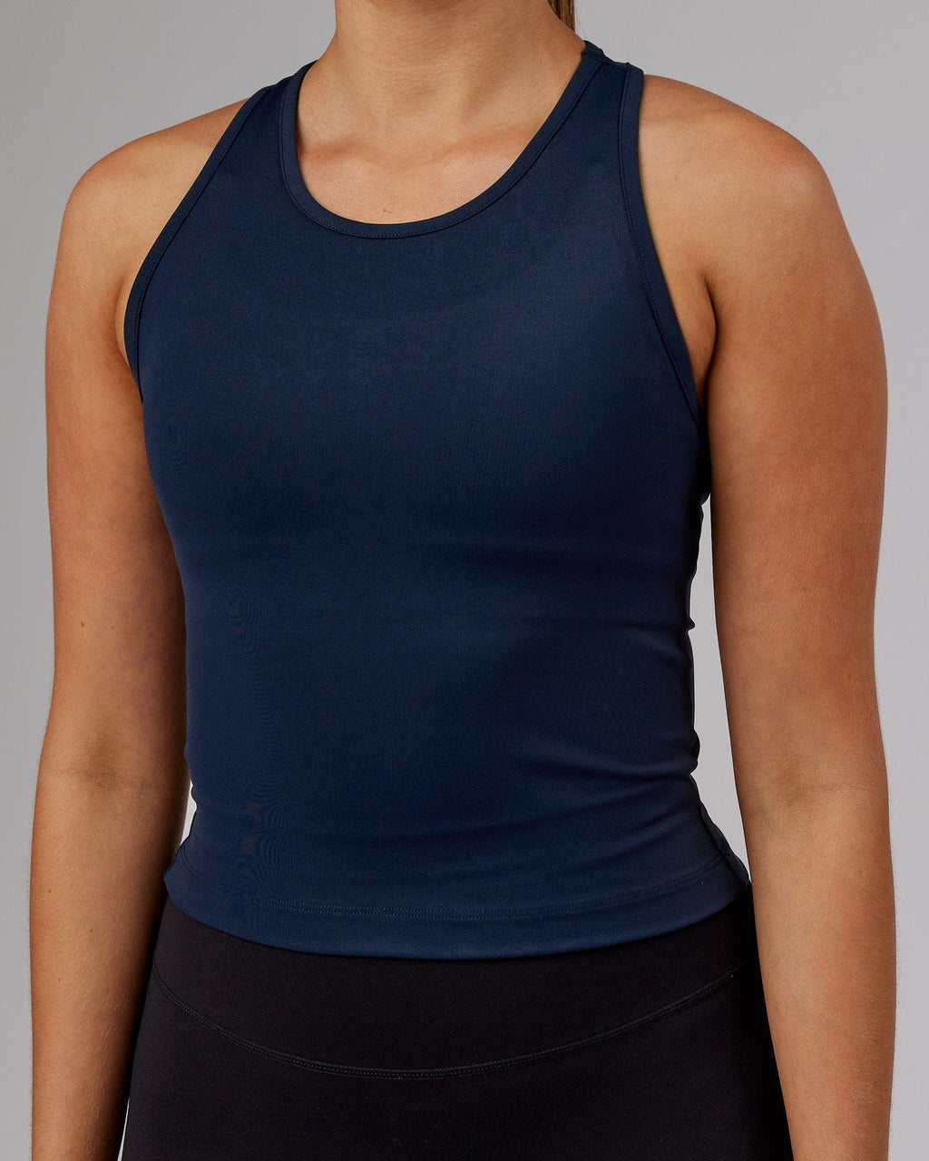 Model wearing Flow Performance Tank - Navy