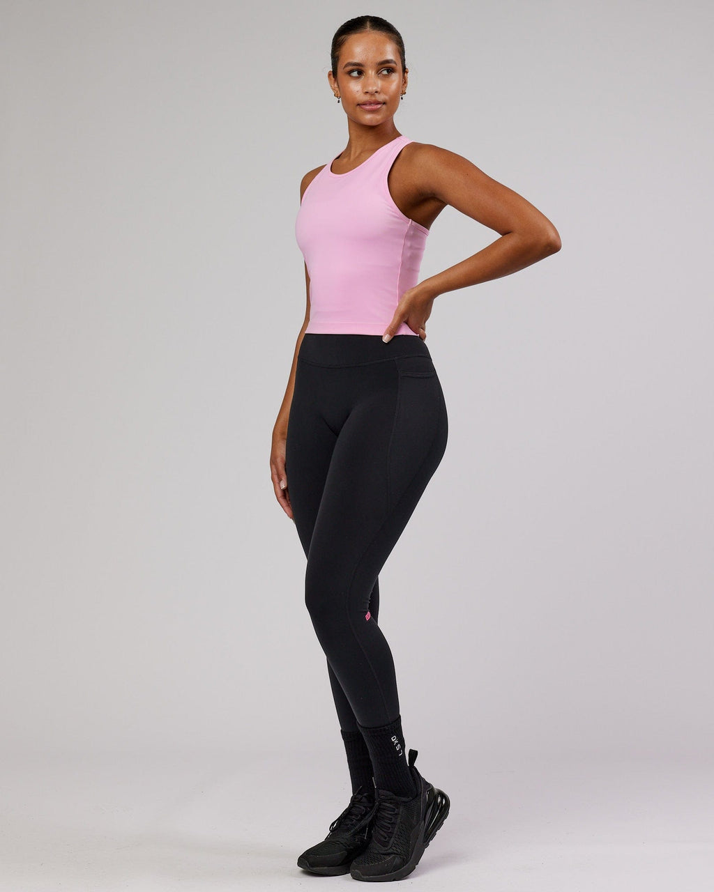 Model wearing Flow Performance Tank - Pink Frosting