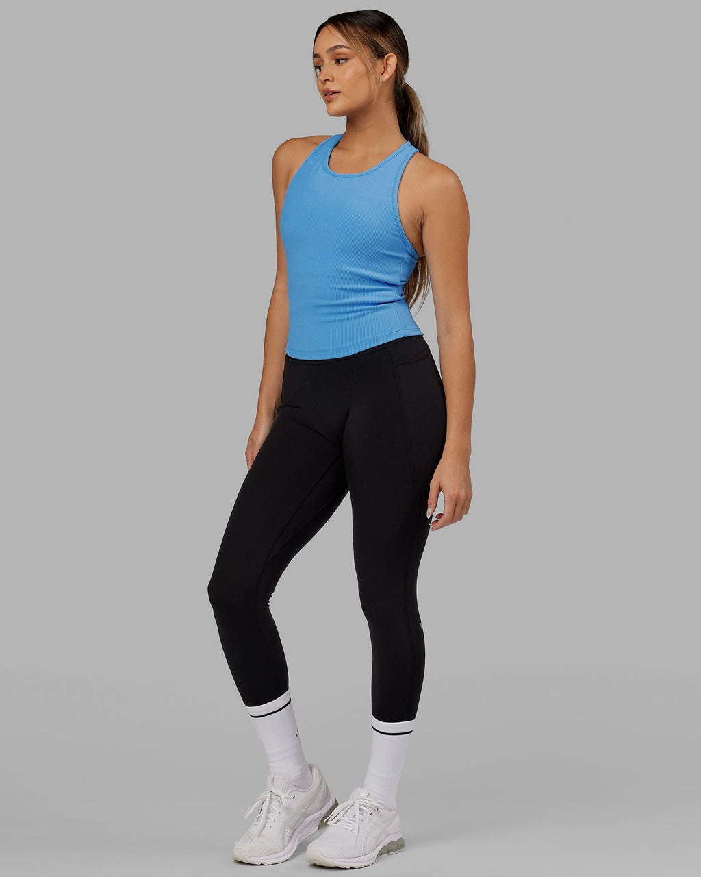 Model wearing Flow Ribbed Shelf Bra Performance Tank - Azure Blue