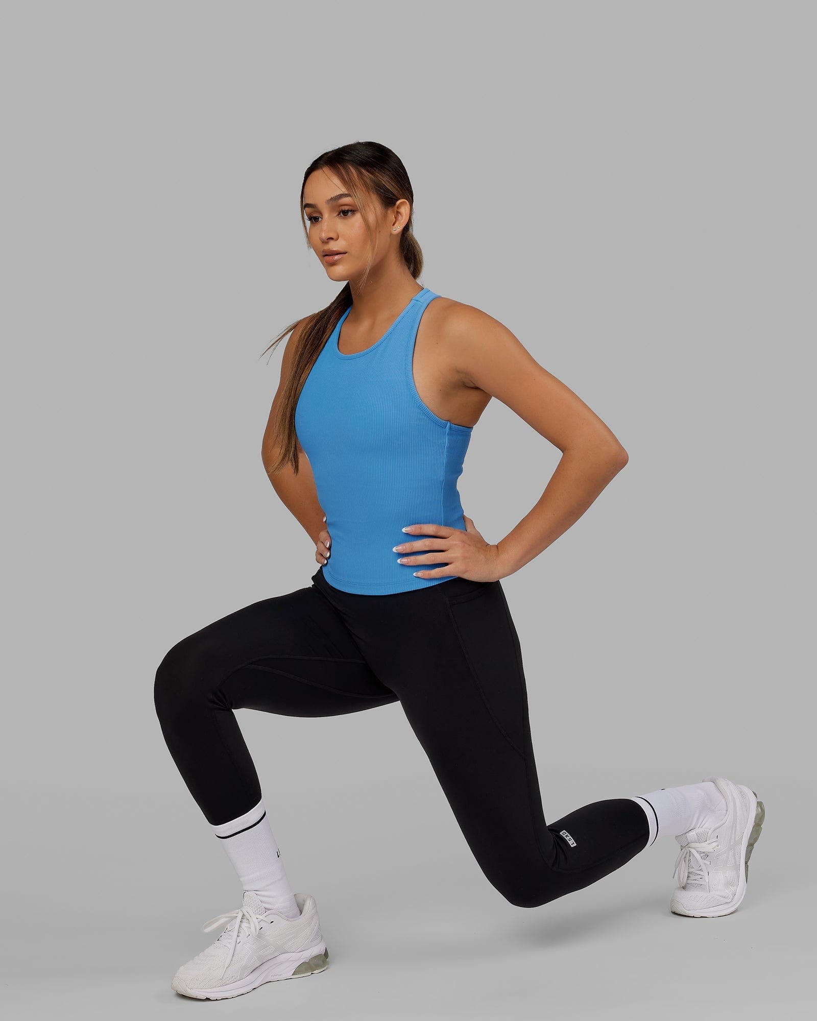 Model wearing Flow Ribbed Shelf Bra Performance Tank - Azure Blue