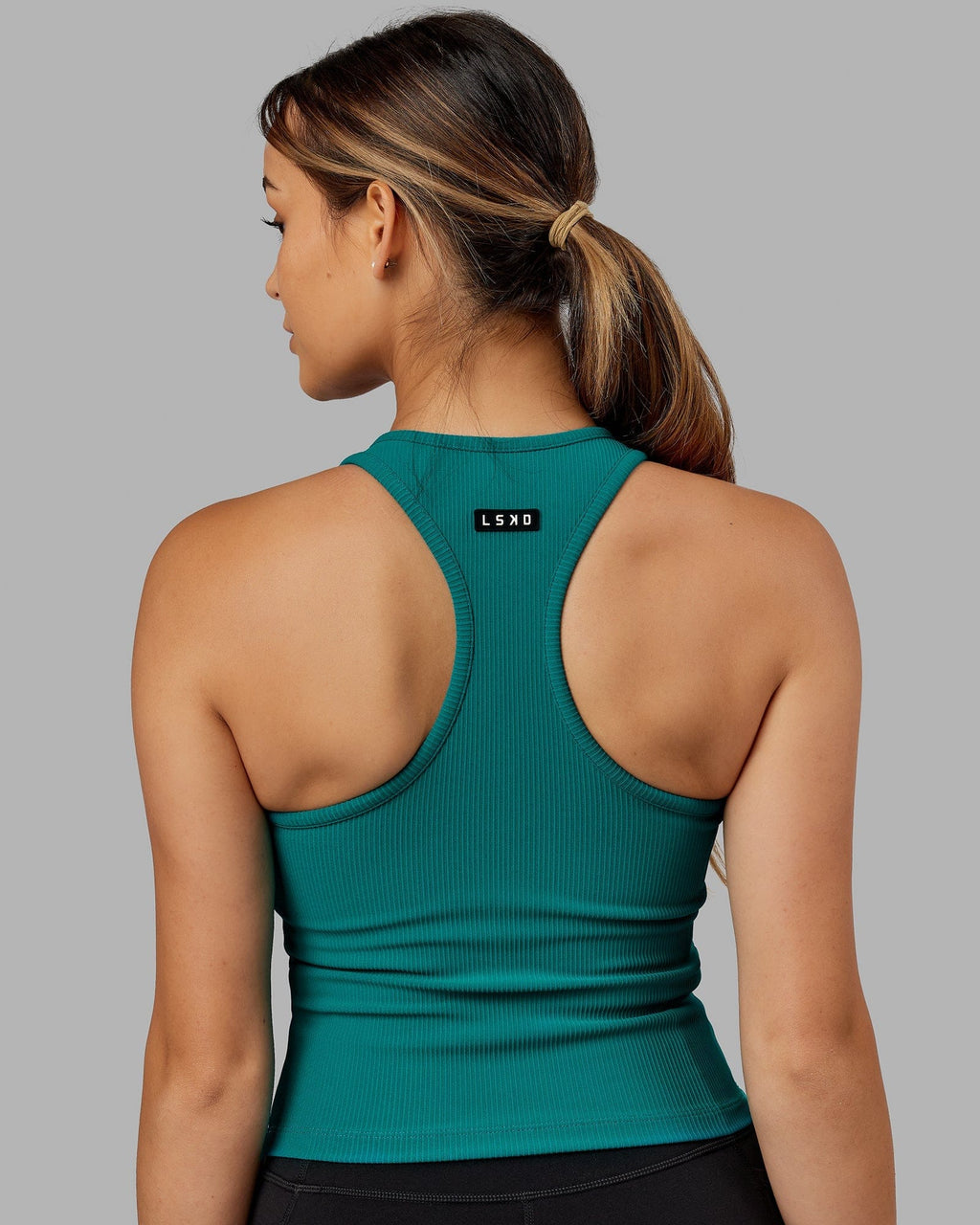 Model wearing Flow Ribbed Shelf Bra Performance Tank - Sea Green