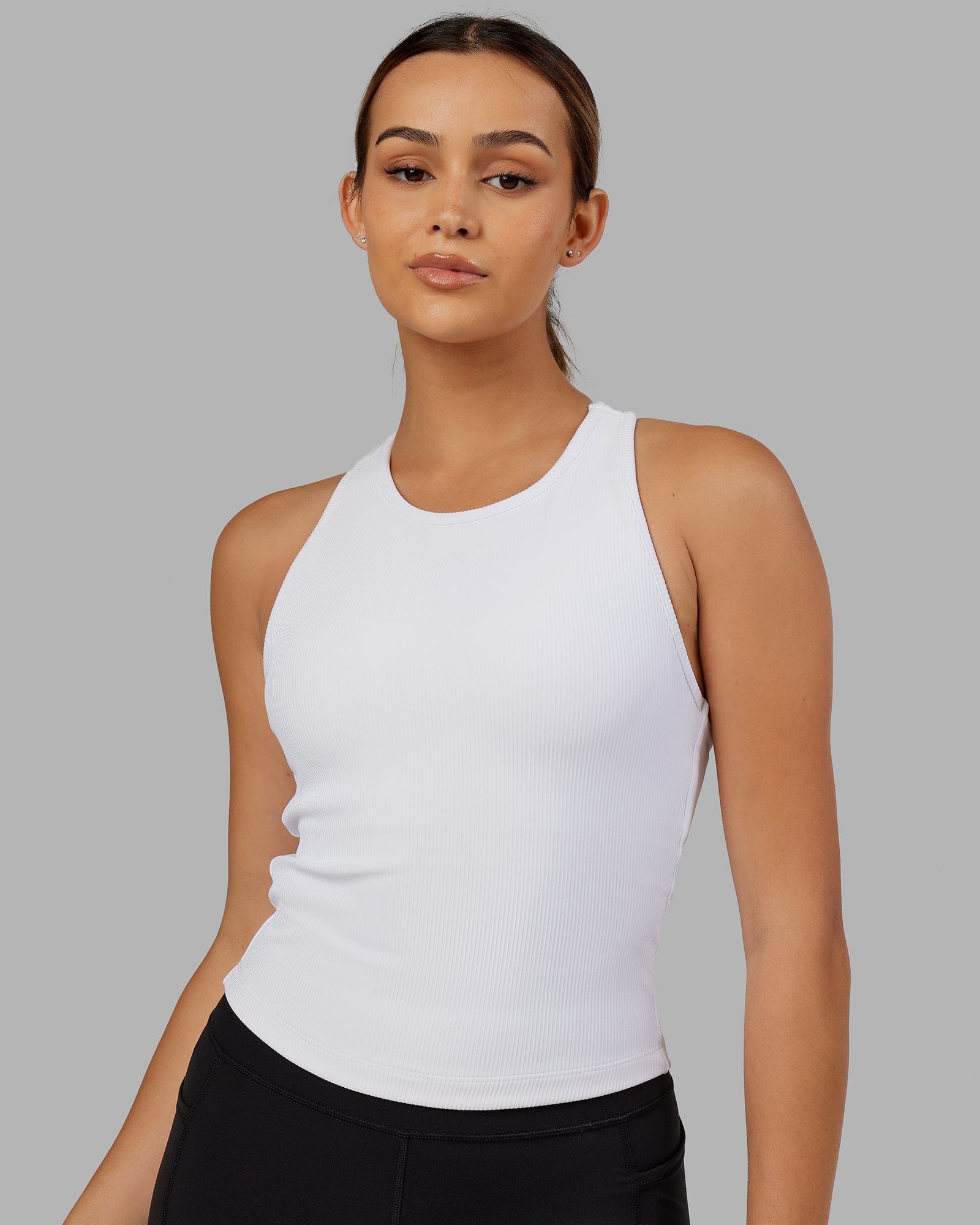 Model wearing Flow Ribbed Shelf Bra Performance Tank - White