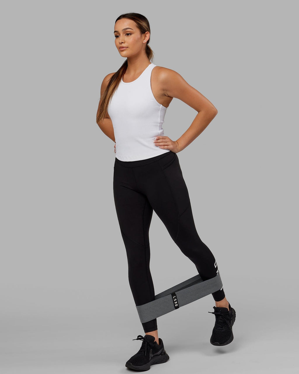 Model wearing Flow Ribbed Shelf Bra Performance Tank - White