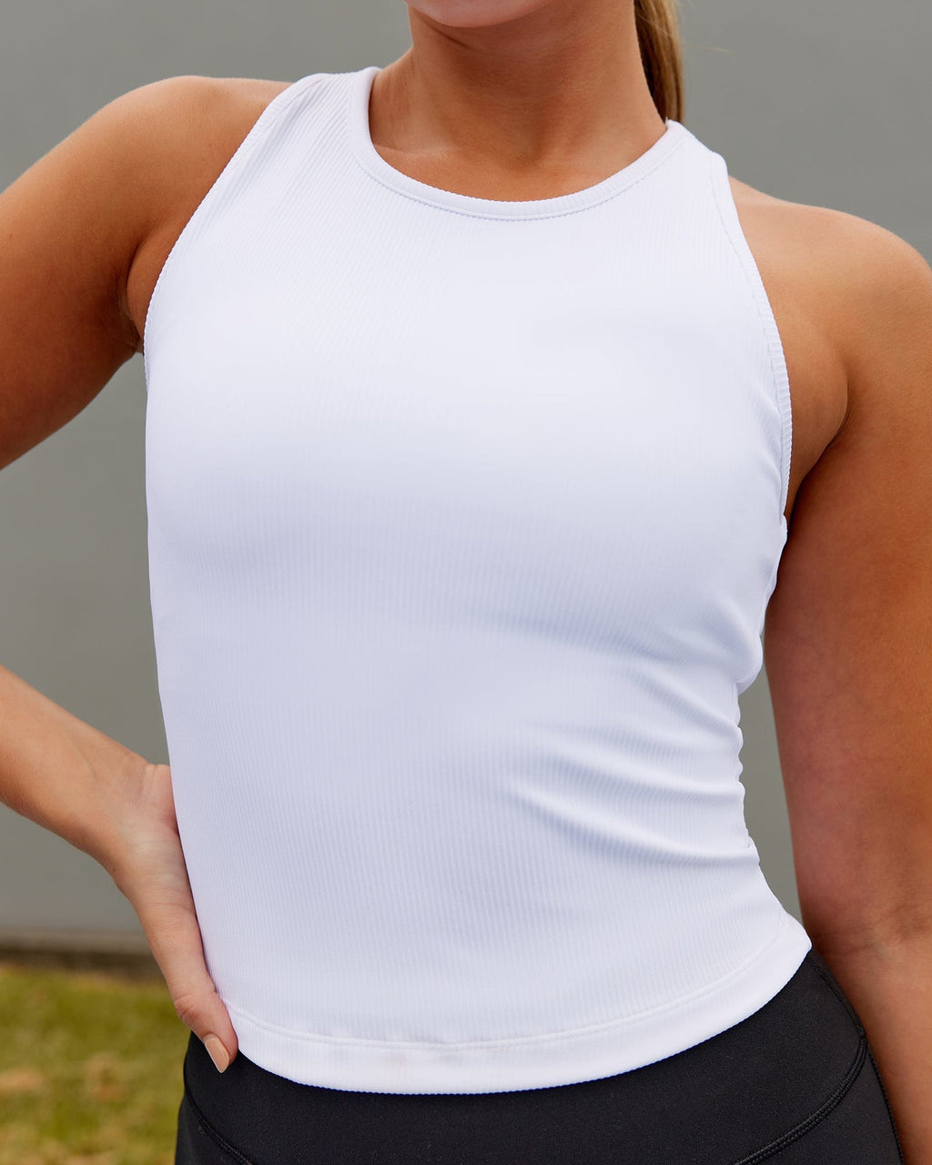 Model wearing Flow Ribbed Shelf Bra Performance Tank - White