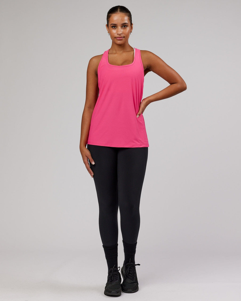 Model wearing Freedom Performance Tank - Flamingo