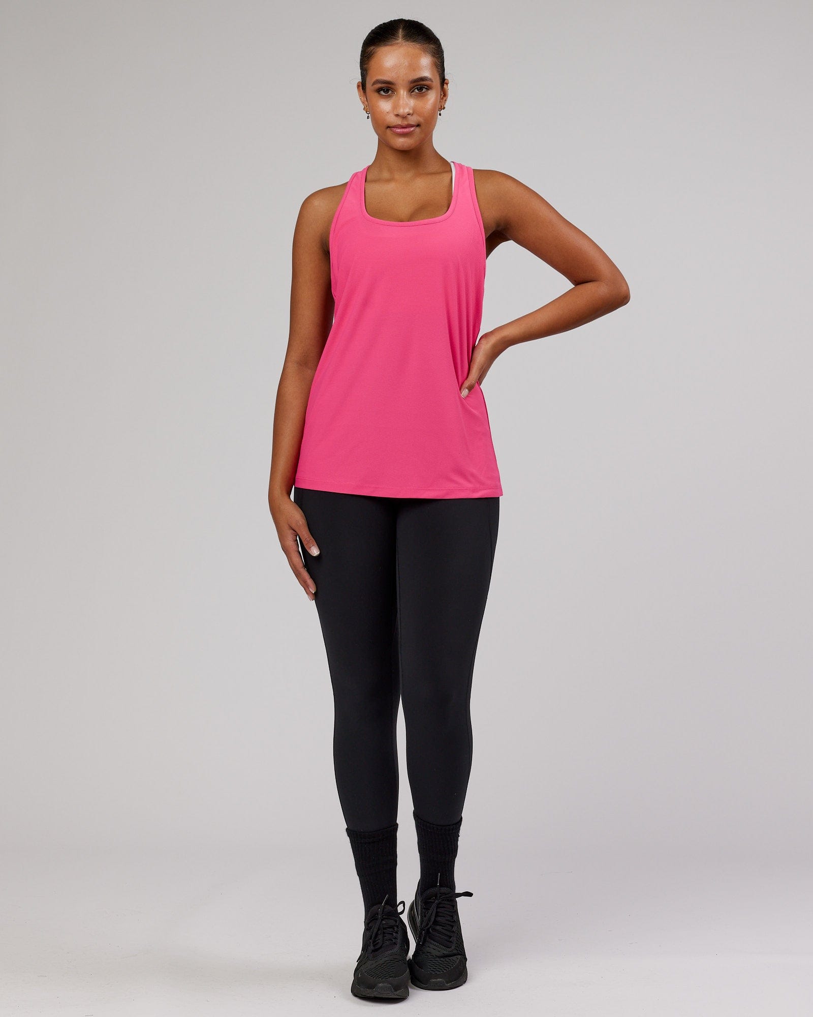 Model wearing Freedom Performance Tank - Flamingo