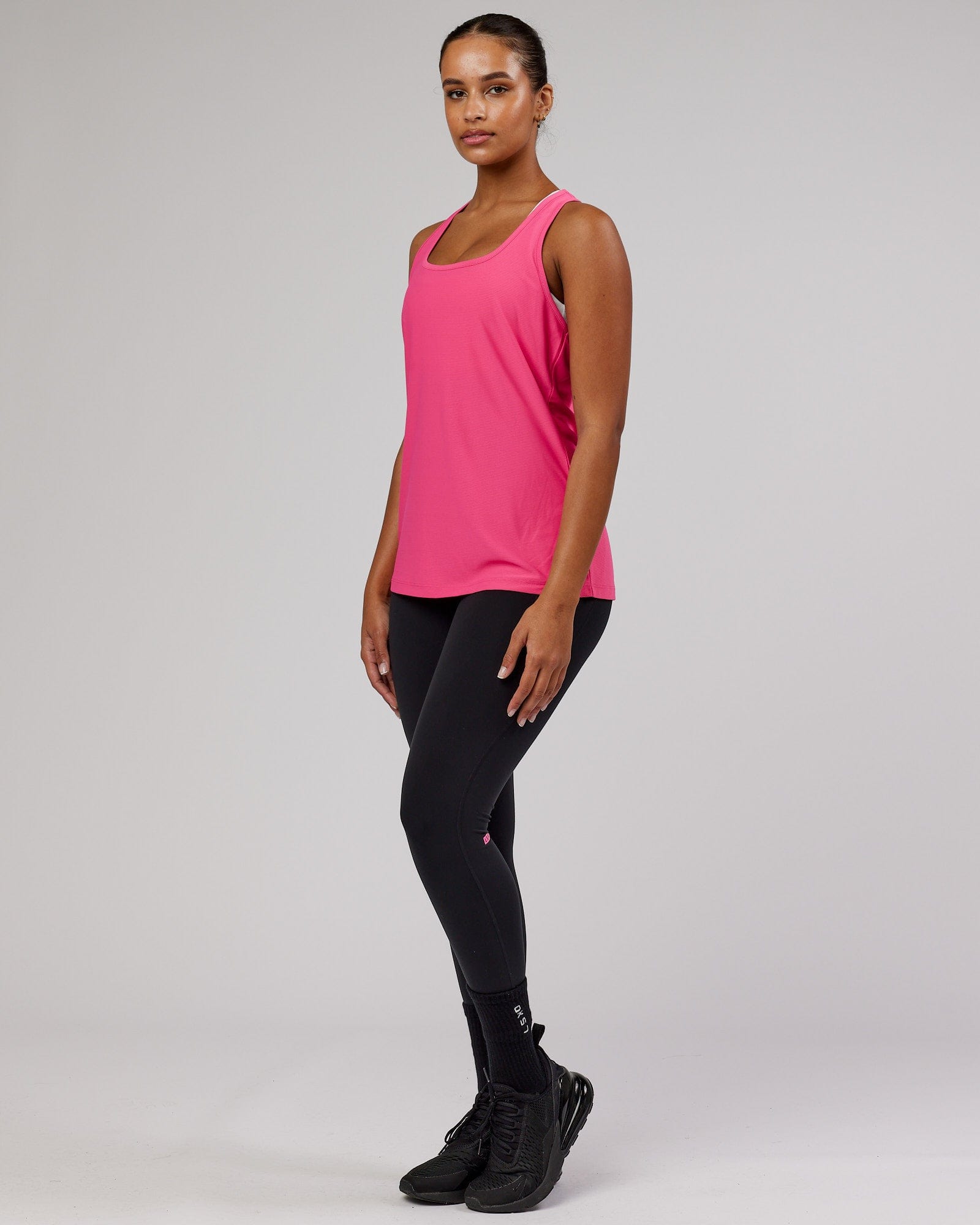 Model wearing Freedom Performance Tank - Flamingo