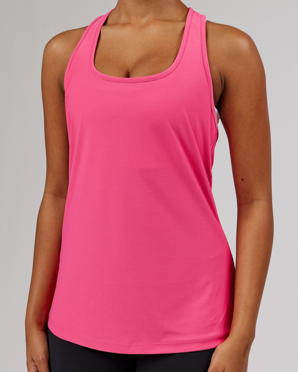 Model wearing Freedom Performance Tank - Flamingo