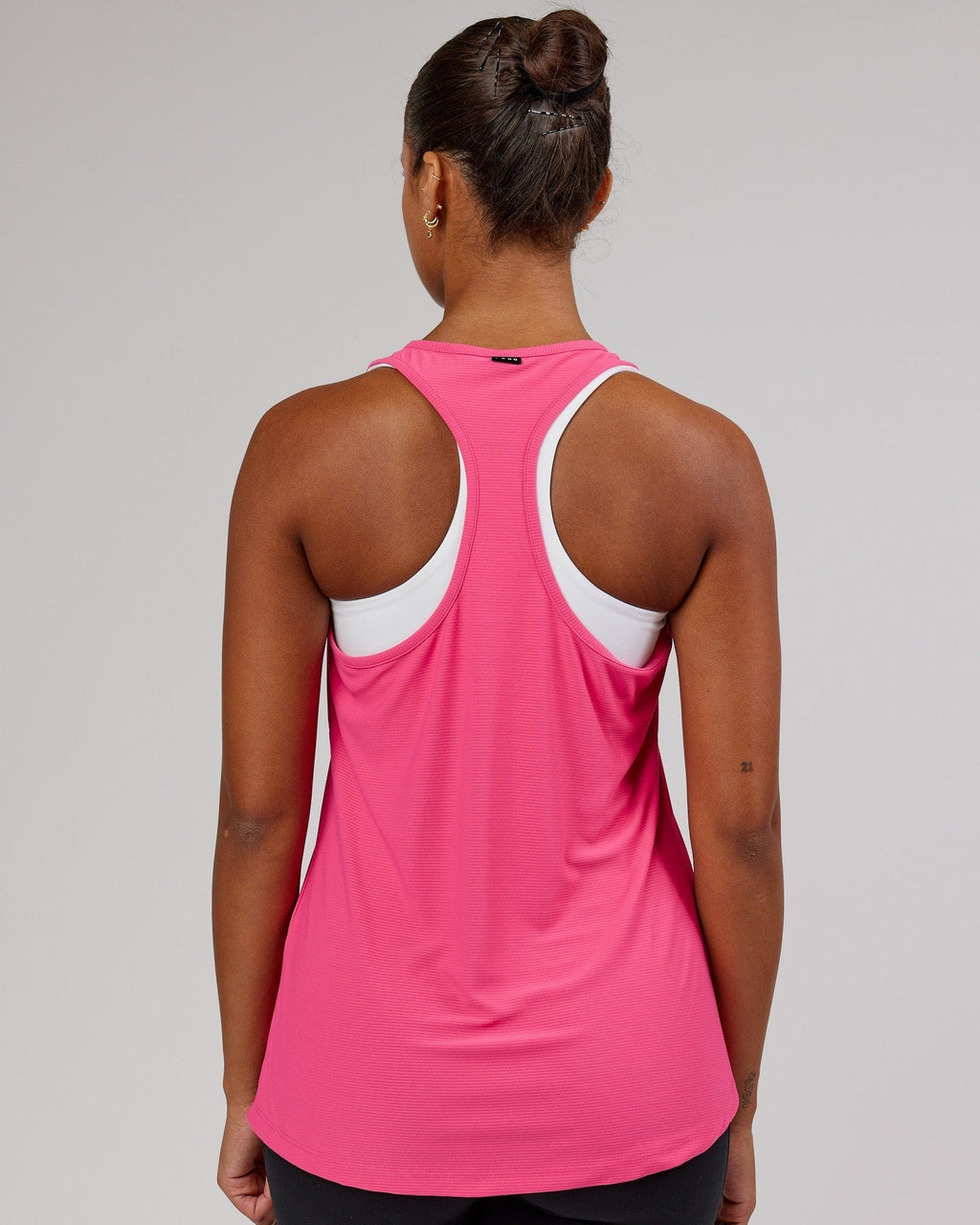 Model wearing Freedom Performance Tank - Flamingo