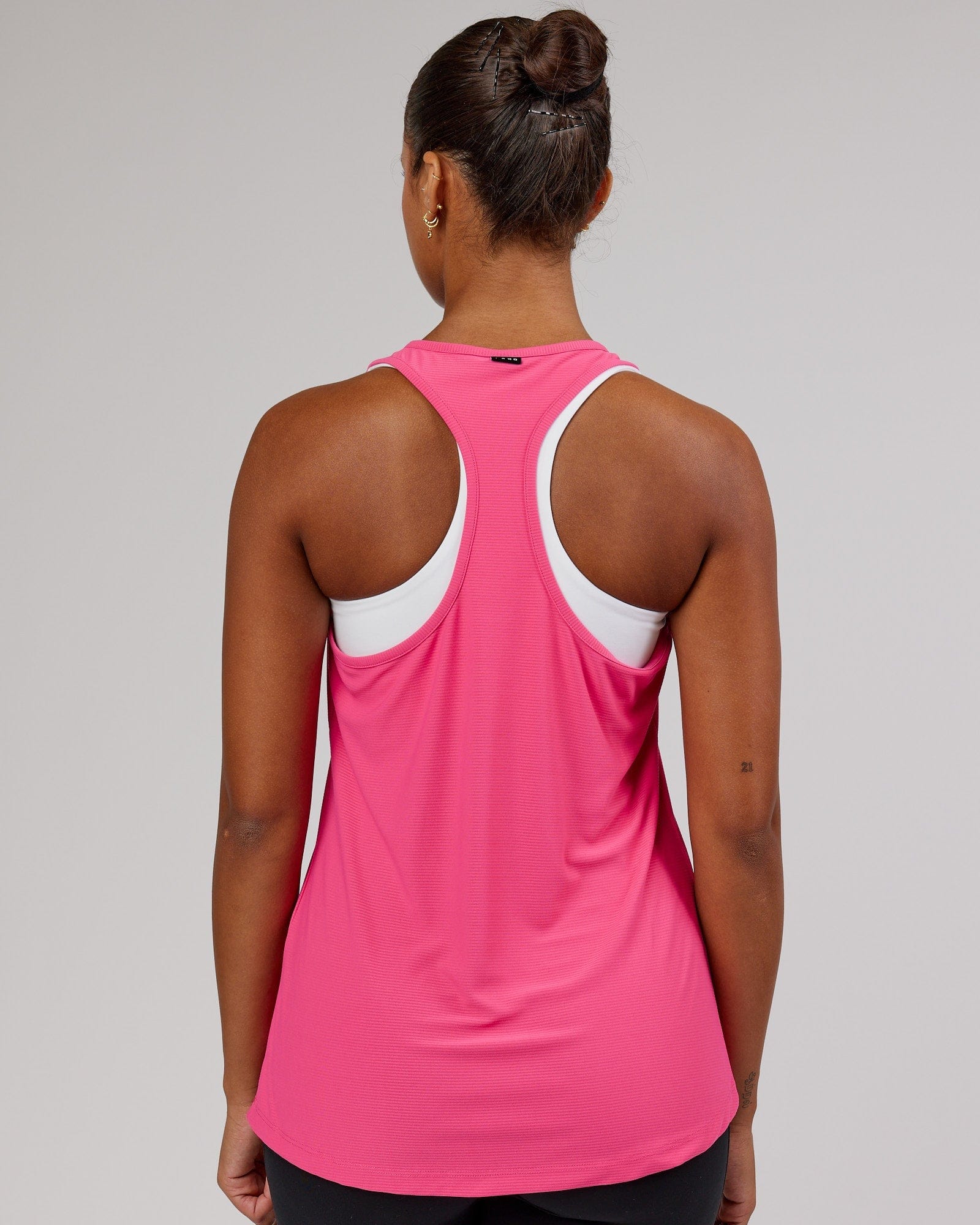 Model wearing Freedom Performance Tank - Flamingo