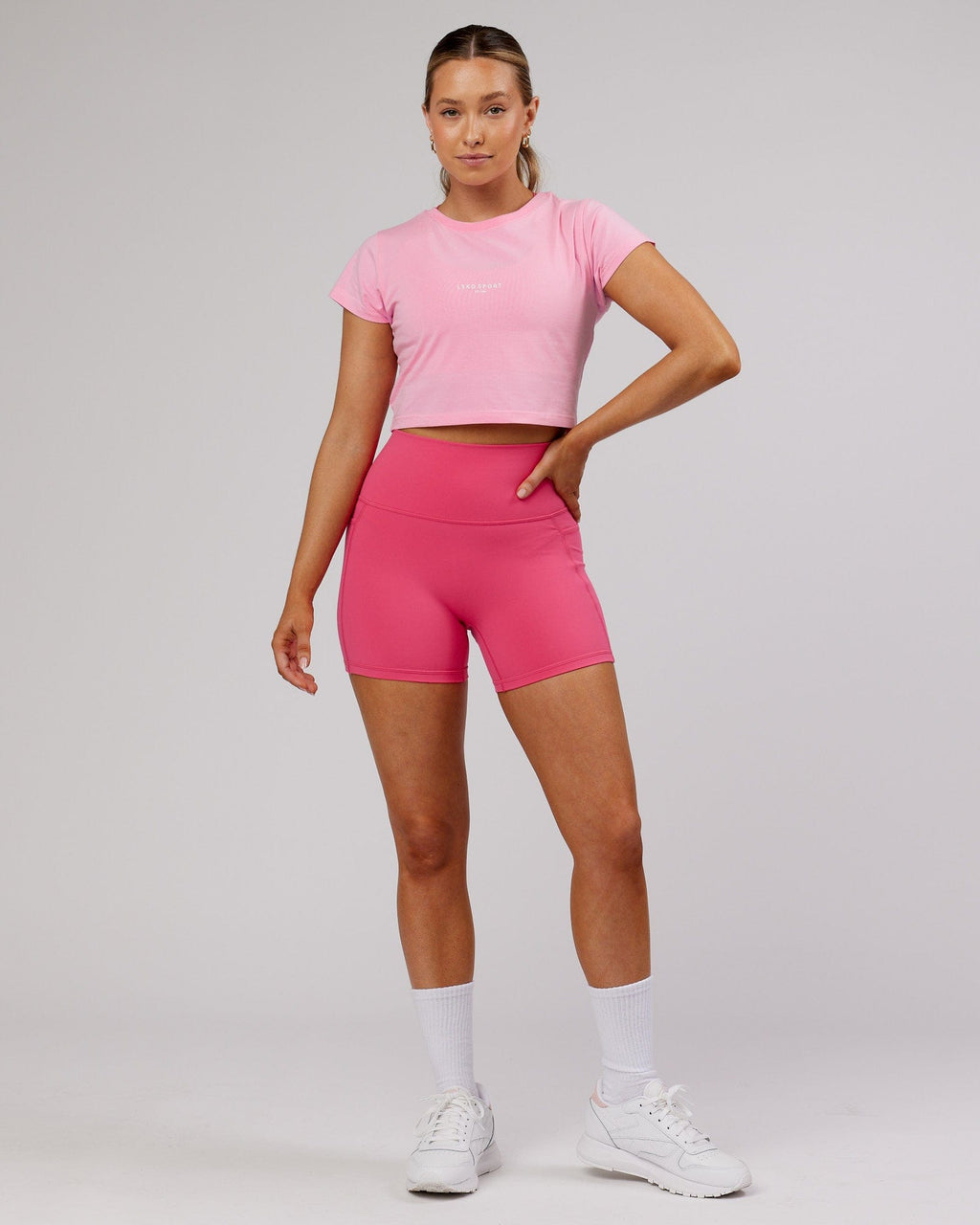 Model wearing Front Runner Baby Tee - Pink Frosting