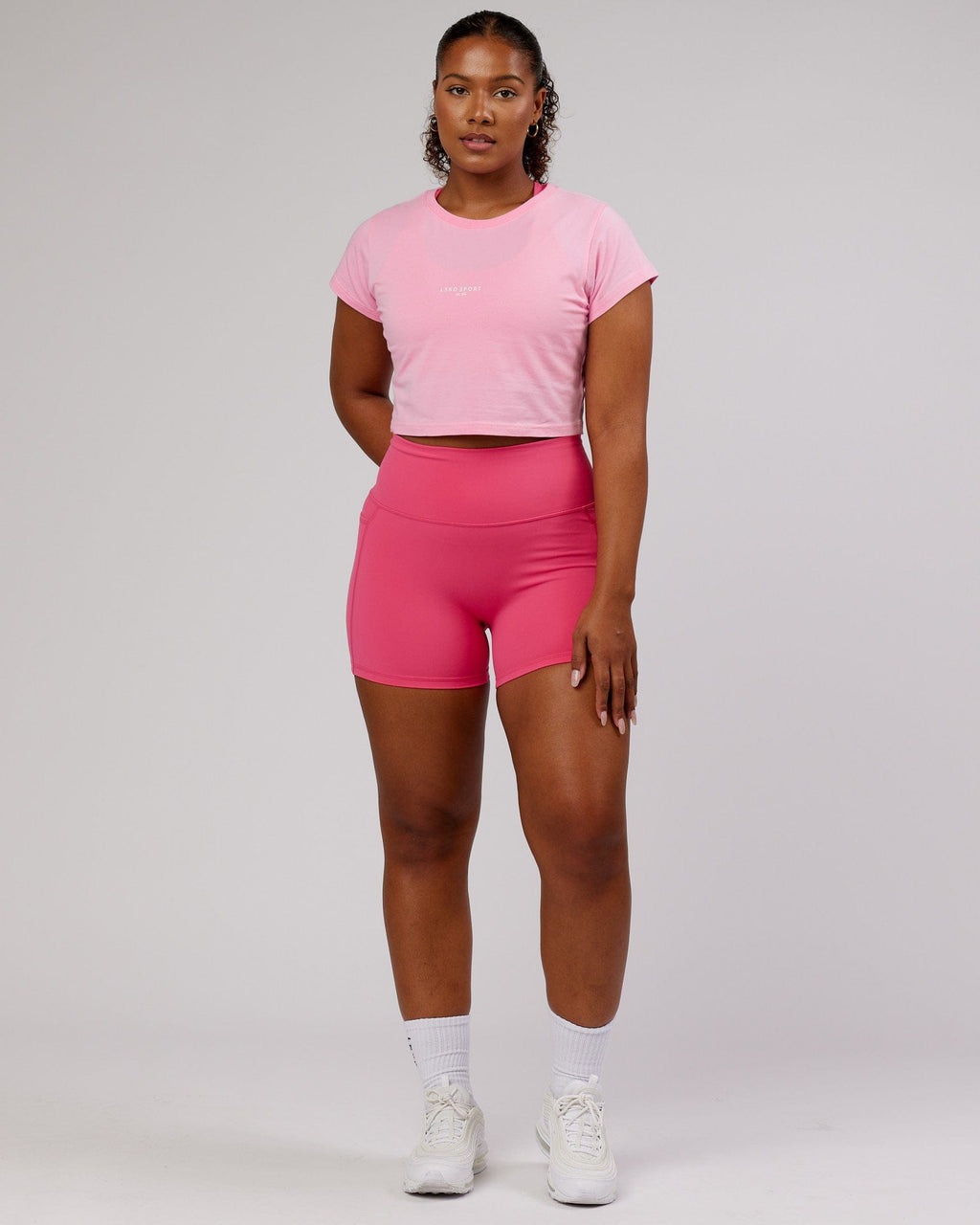 Model wearing Front Runner Baby Tee - Pink Frosting