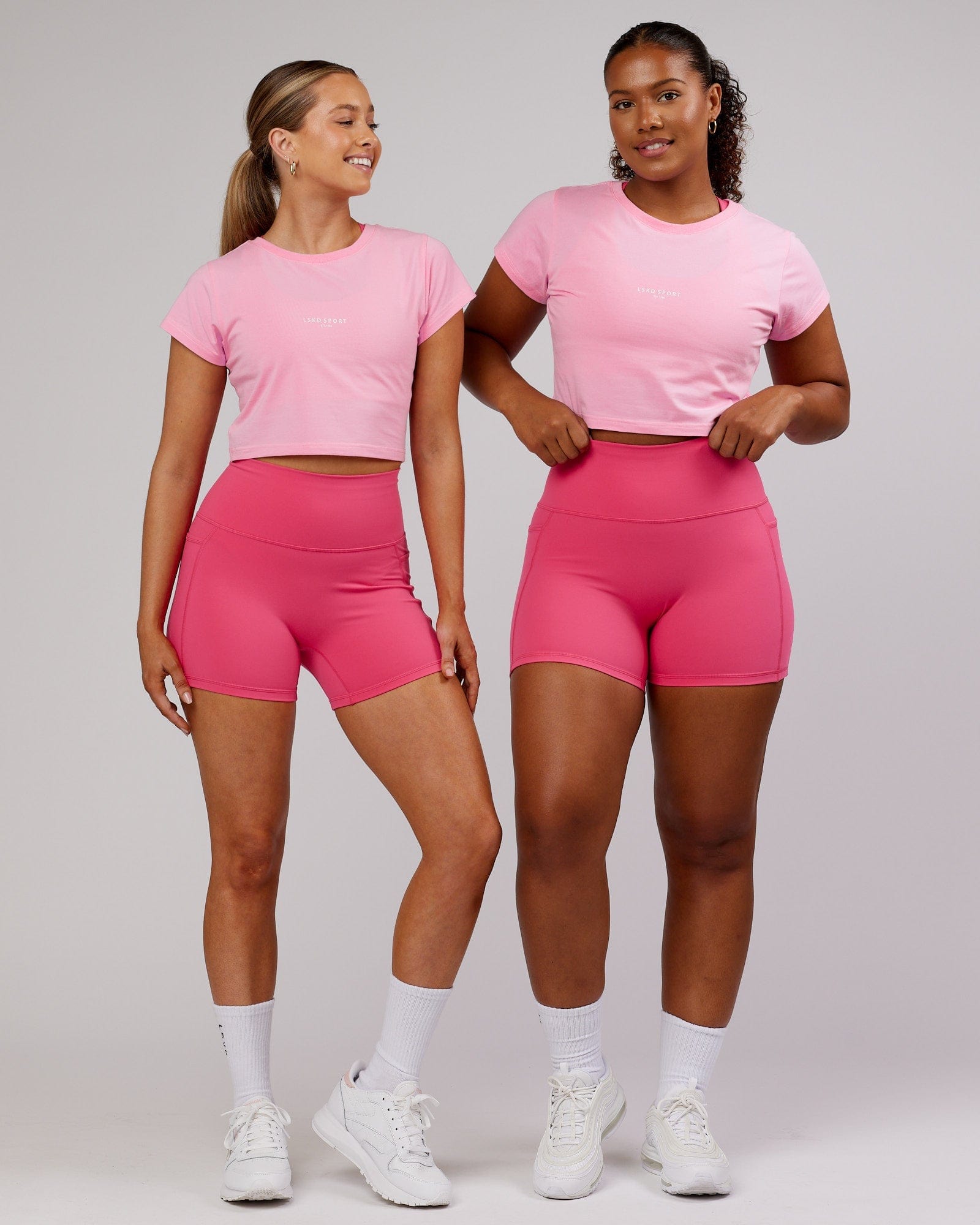 Model wearing Front Runner Baby Tee - Pink Frosting