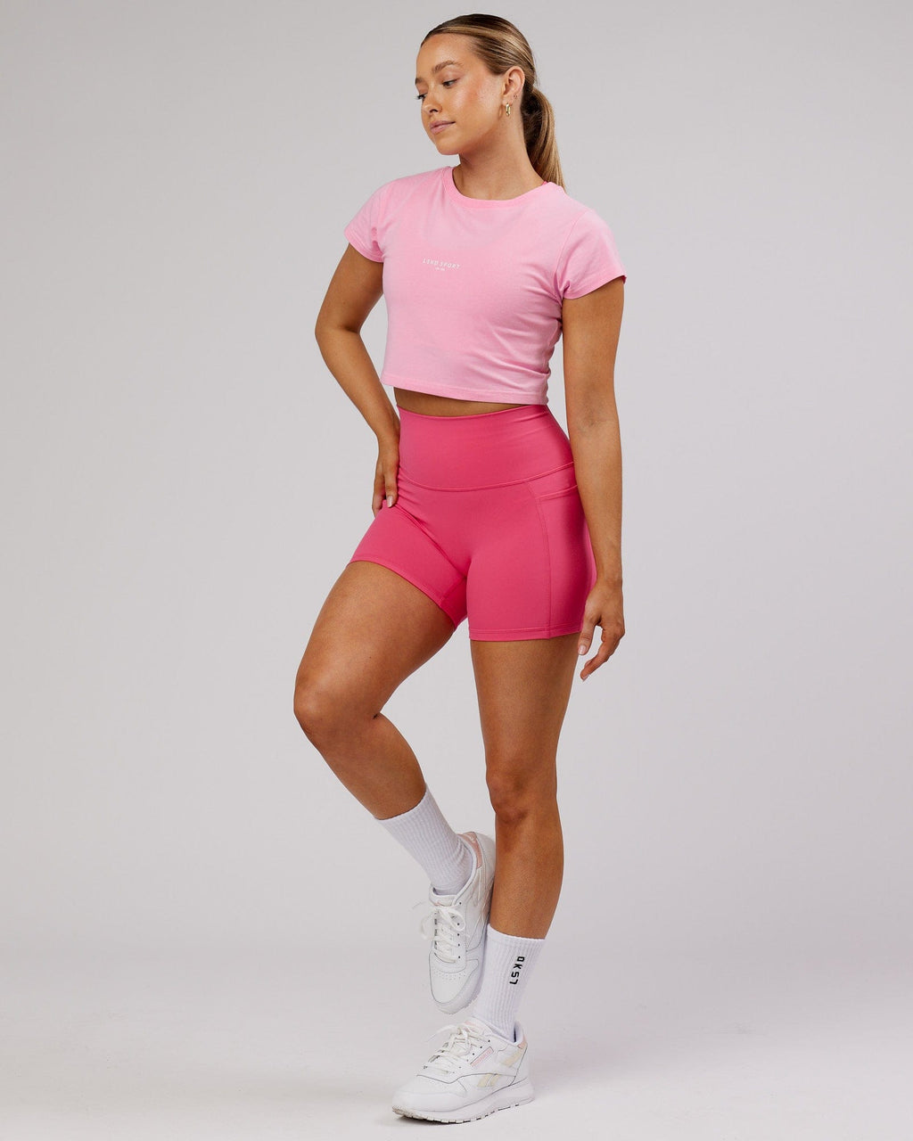 Model wearing Front Runner Baby Tee - Pink Frosting