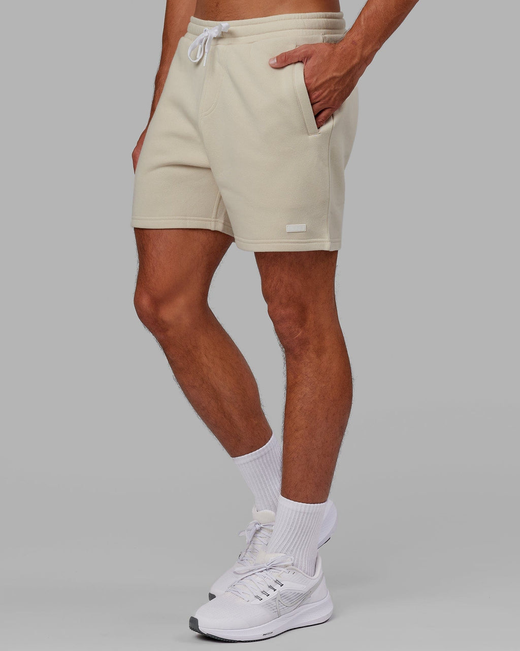 Model wearing Fundamental Track Short - Bone