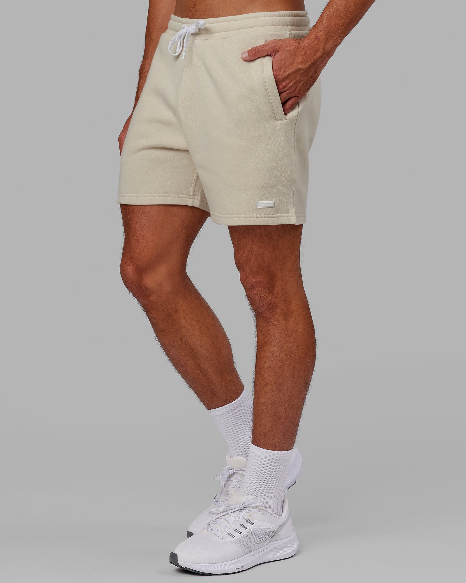 Model wearing Fundamental Track Short - Bone