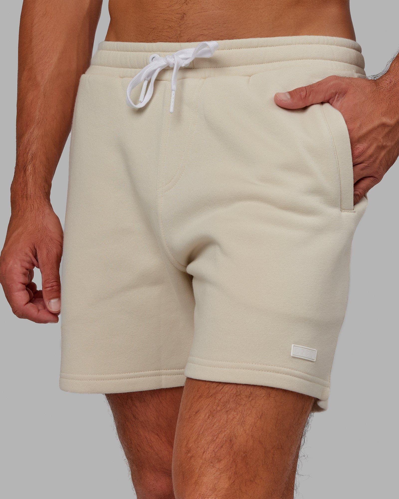 Model wearing Fundamental Track Short - Bone