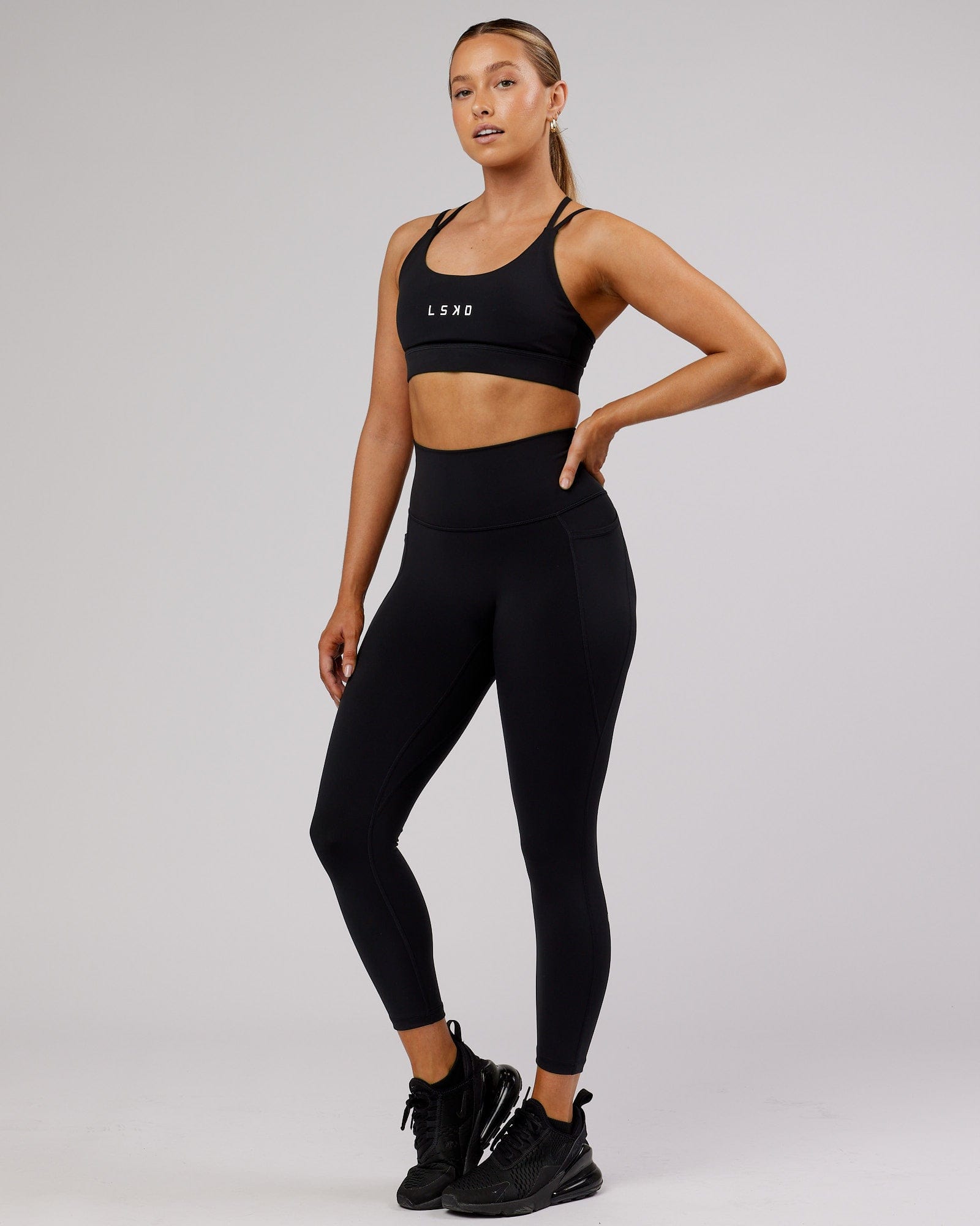 Model wearing Fusion 7/8 Length Tight - Black-Flamingo