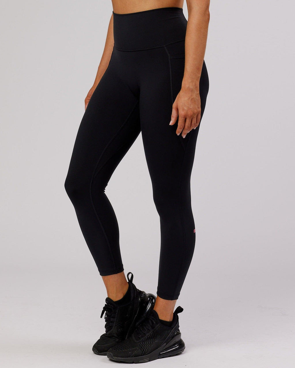 Model wearing Fusion 7/8 Length Tight - Black-Flamingo