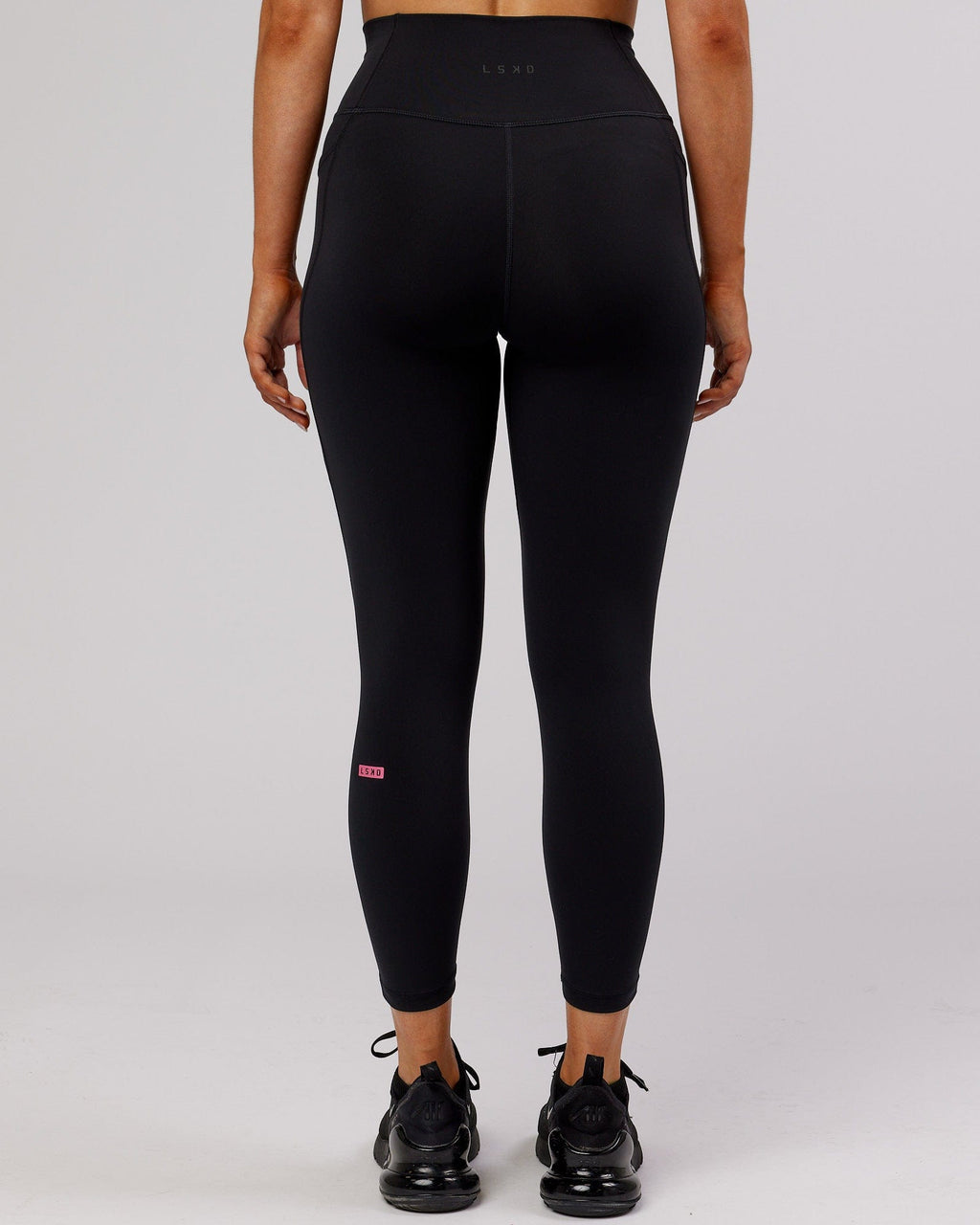 Model wearing Fusion 7/8 Length Tight - Black-Flamingo