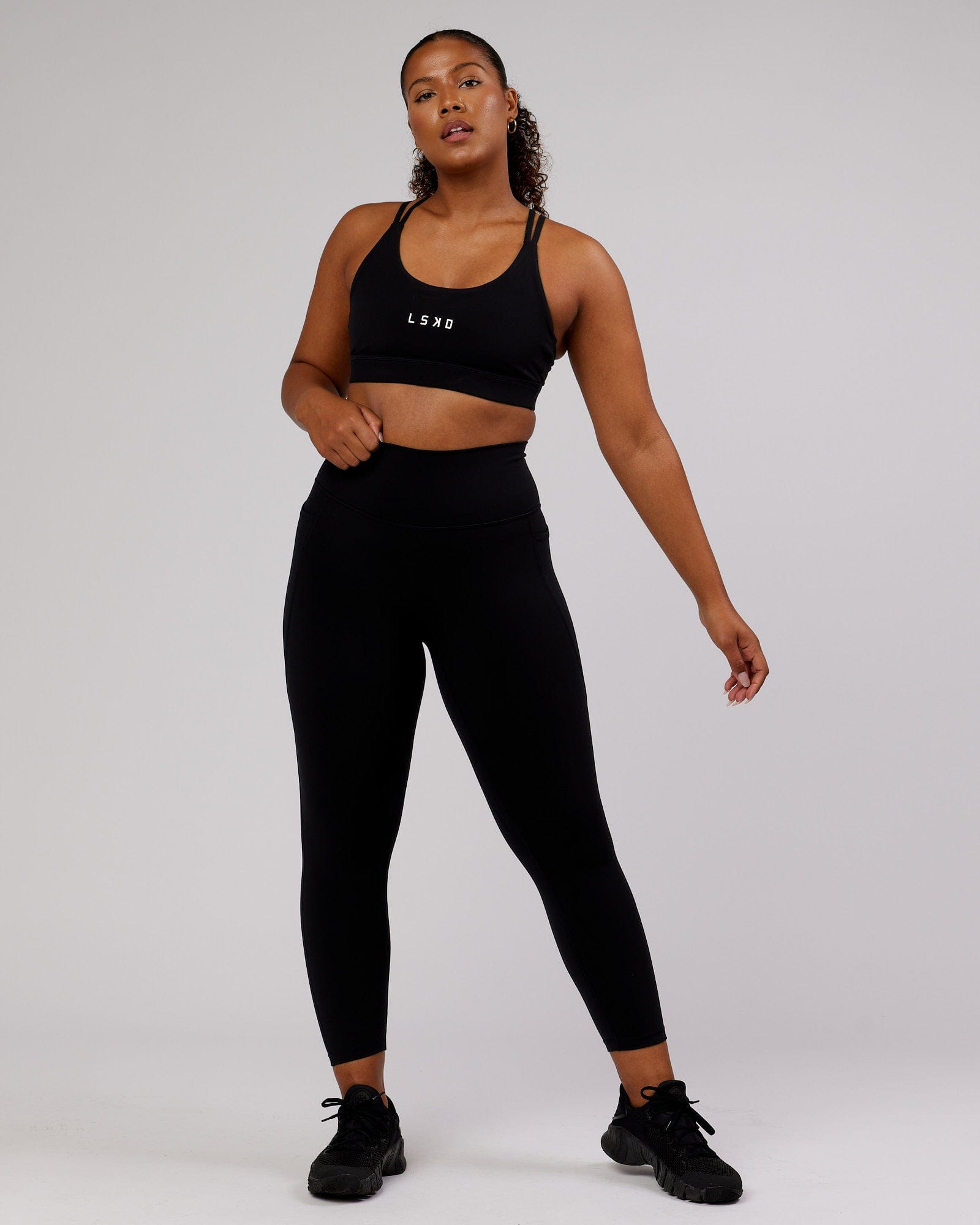 Model wearing Fusion 7/8 Length Tight - Black-Flamingo