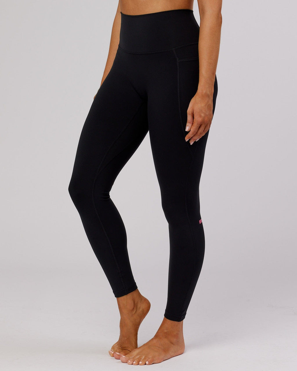 Model wearing Fusion Full Length Tight - Black-Flamingo