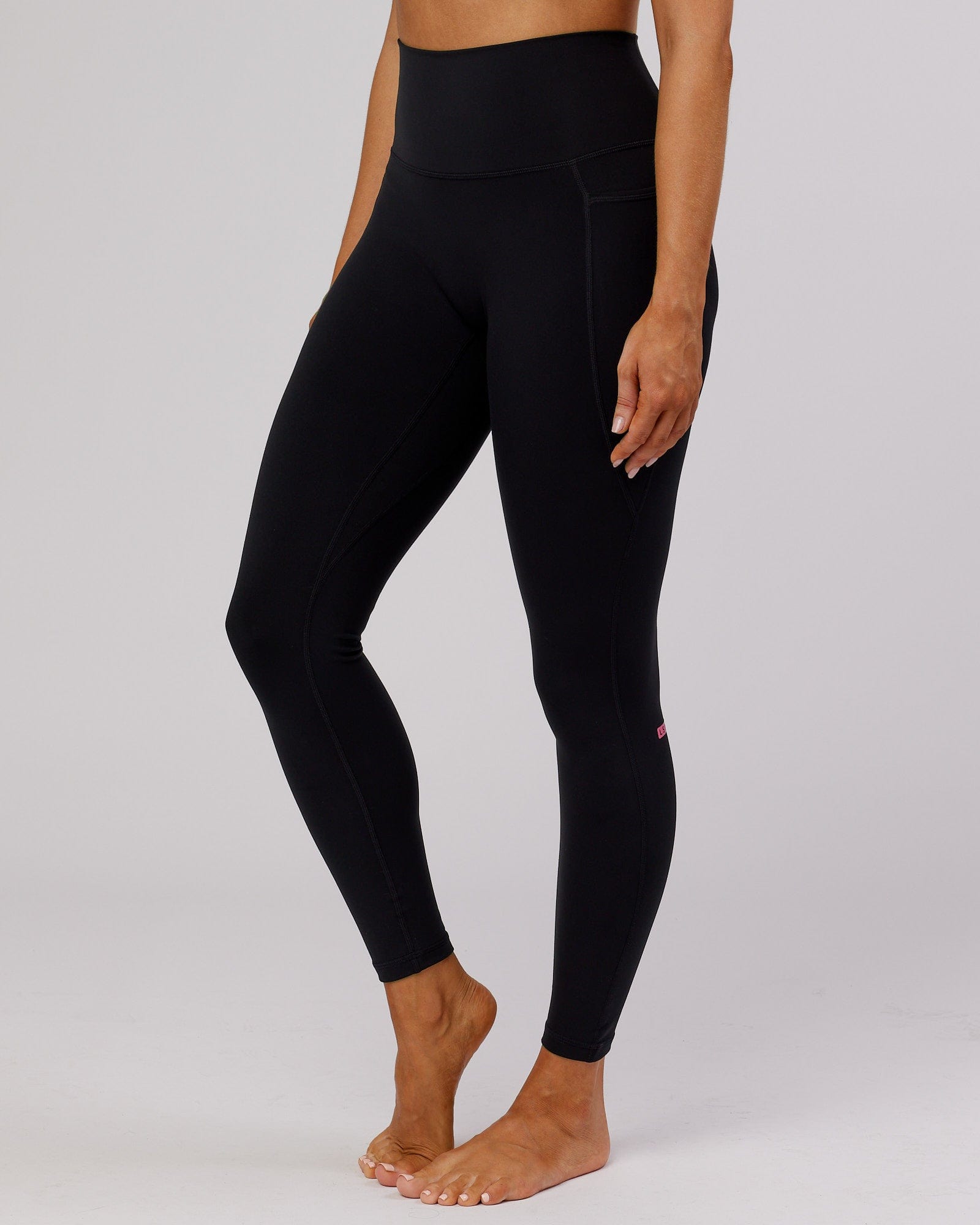 Model wearing Fusion Full Length Tight - Black-Flamingo