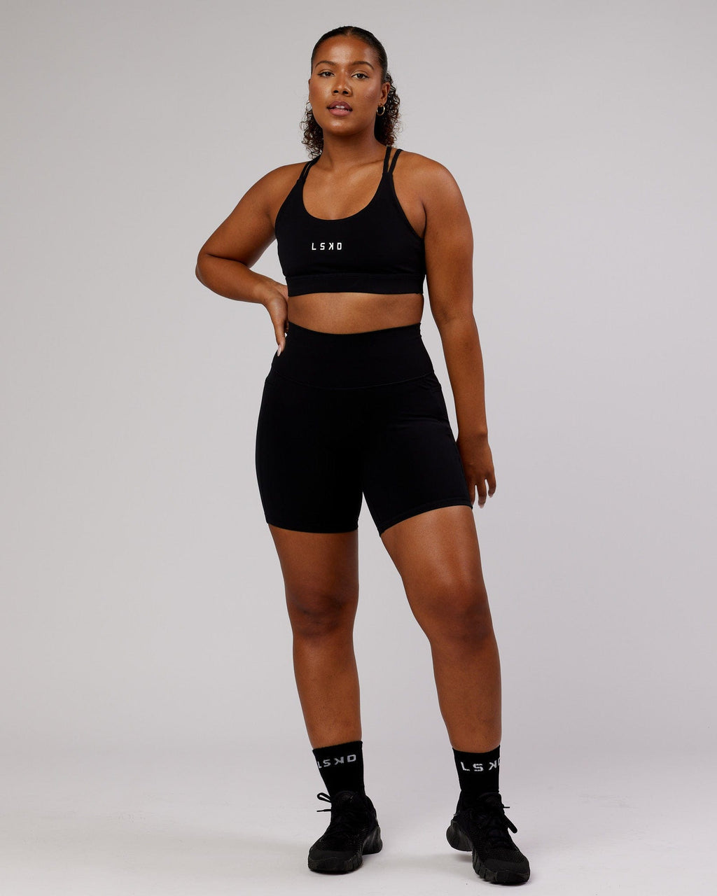 Model wearing Fusion Mid Short Tight - Black-Flamingo