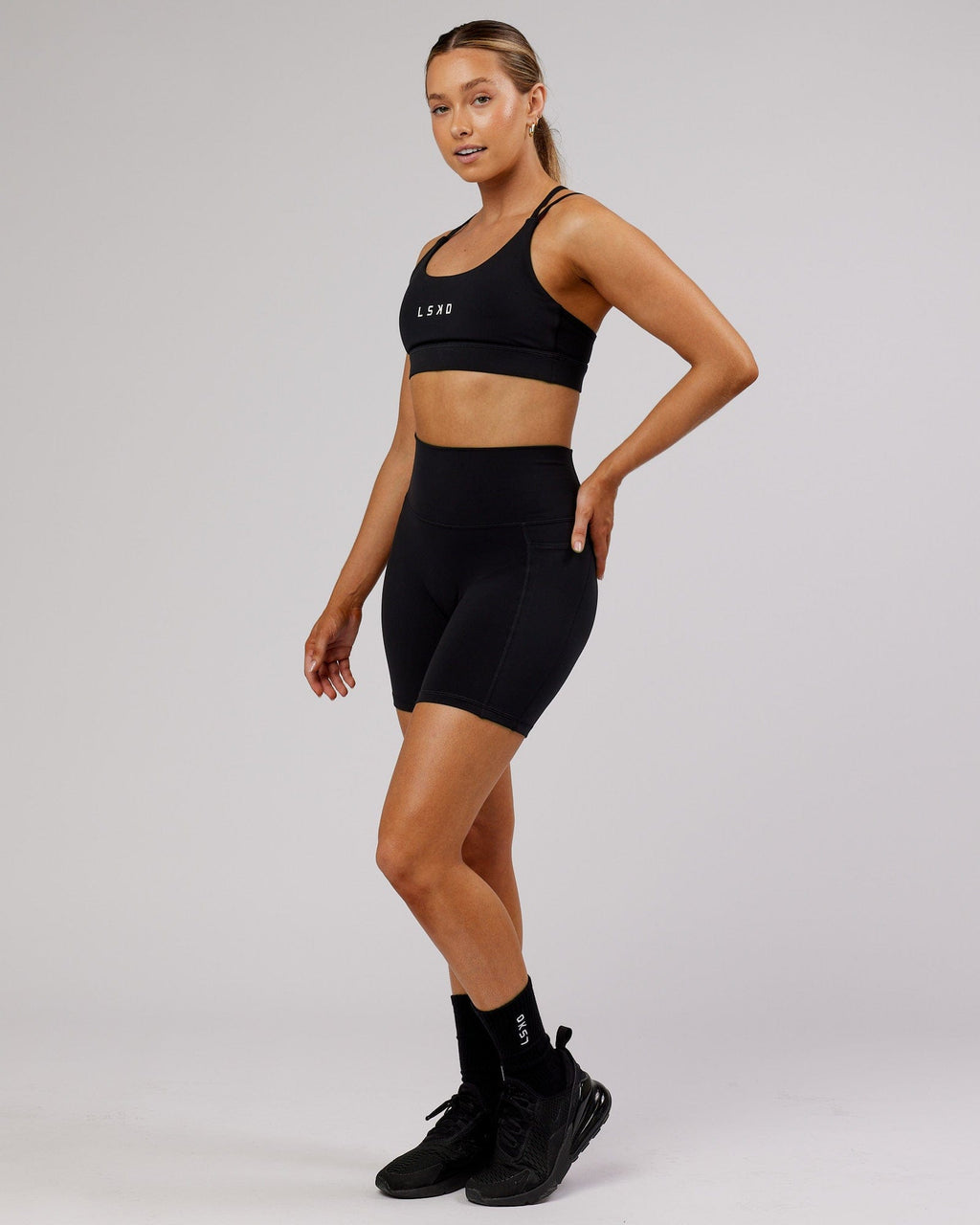 Model wearing Fusion Mid Short Tight - Black-Flamingo