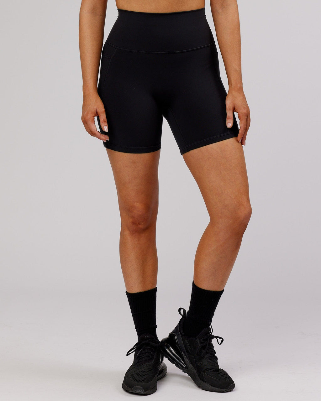 Model wearing Fusion Mid Short Tight - Black-Flamingo