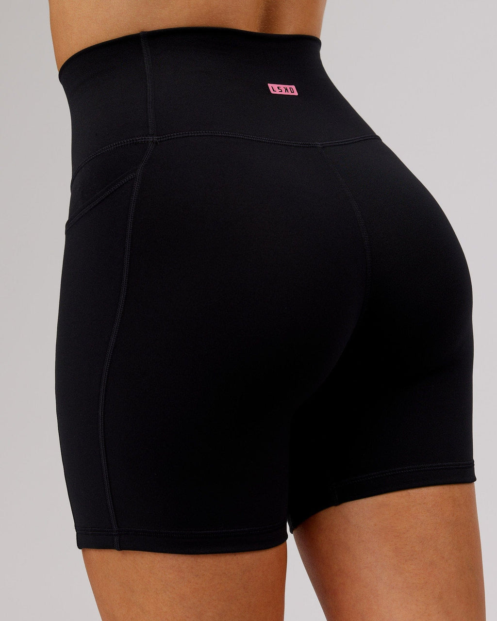Model wearing Fusion Mid Short Tight - Black-Flamingo