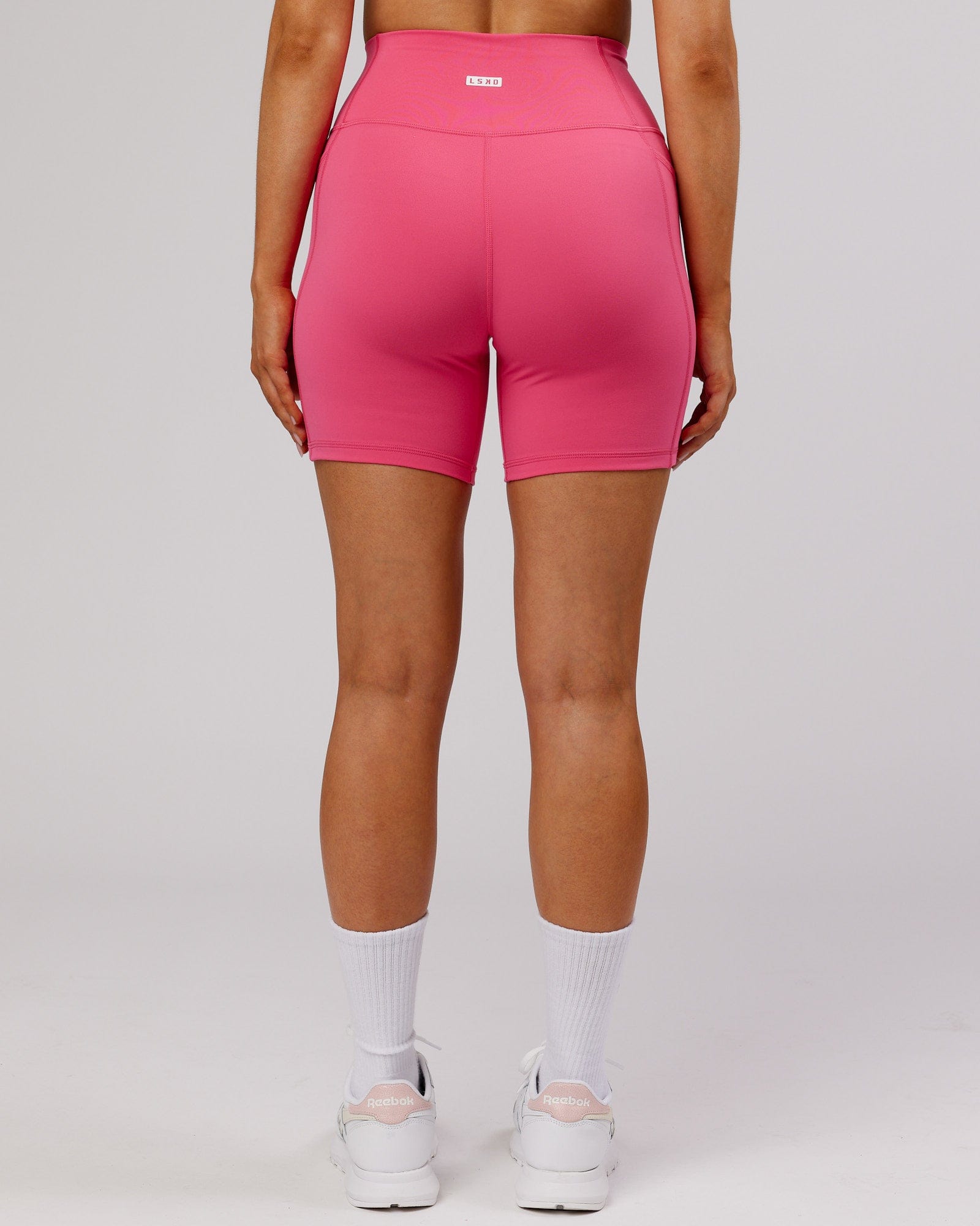 Model wearing Fusion Mid-Short Tight - Flamingo