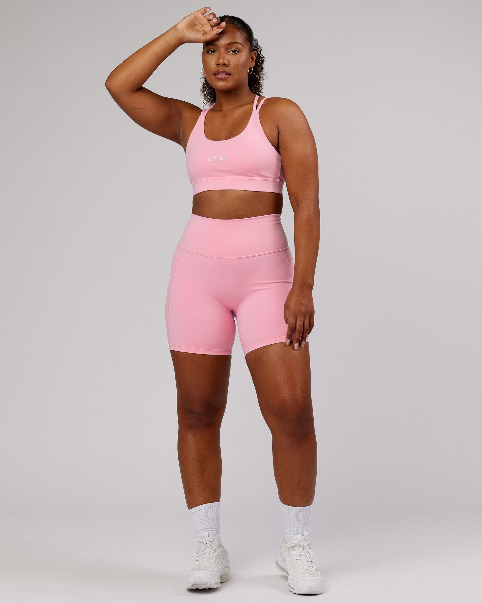 Model wearing Fusion Mid Short Tight - Pink Frosting