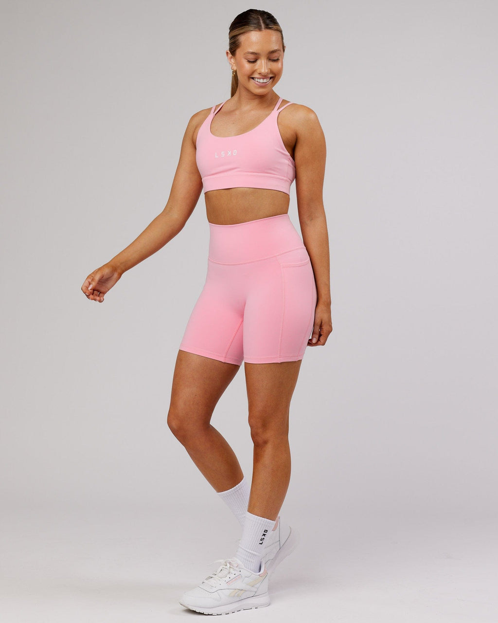 Model wearing Fusion Mid Short Tight - Pink Frosting