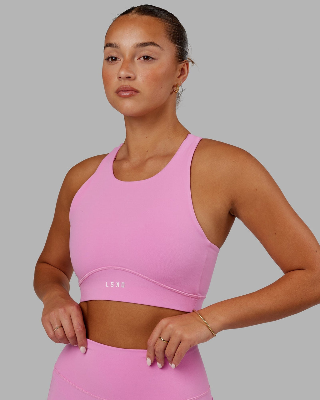 Model wearing Fusion Sports Bra - Spark Pink