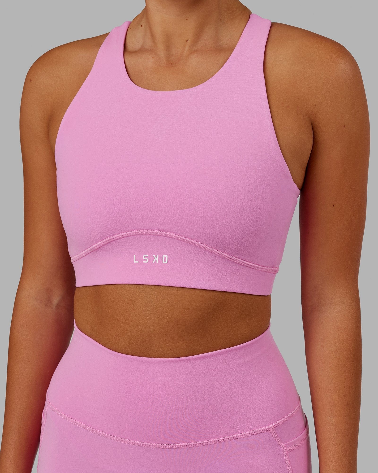 Model wearing Fusion Sports Bra - Spark Pink