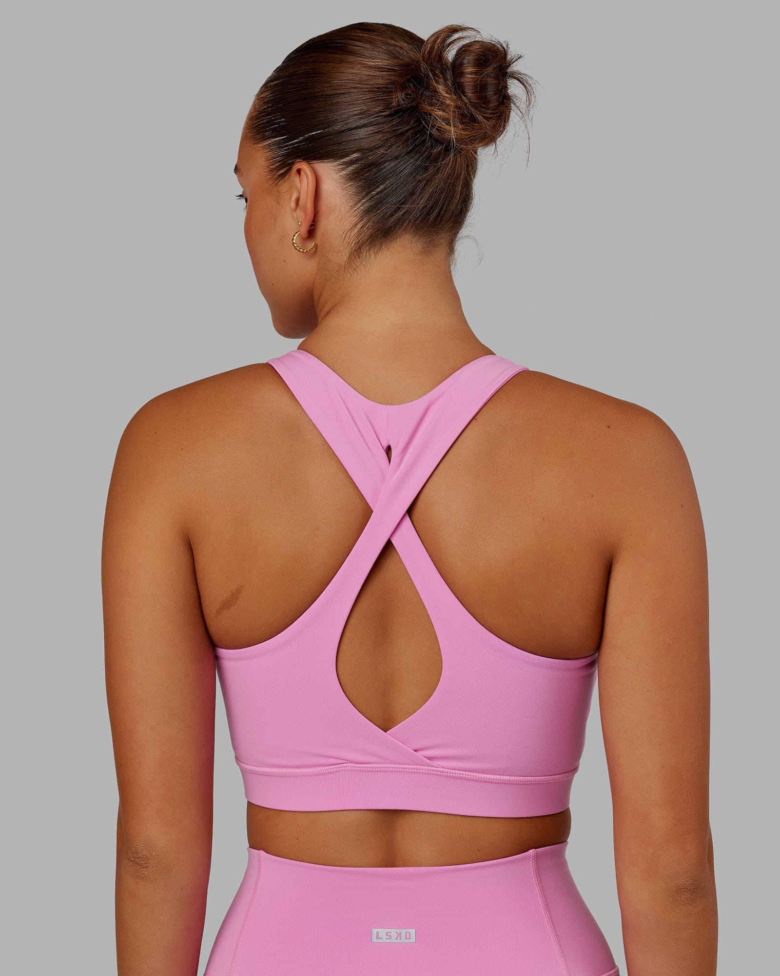 Model wearing Fusion Sports Bra - Spark Pink