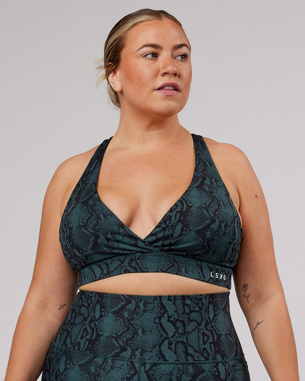 Model wearing Ignite Sports Bra - Forest Snakeskin