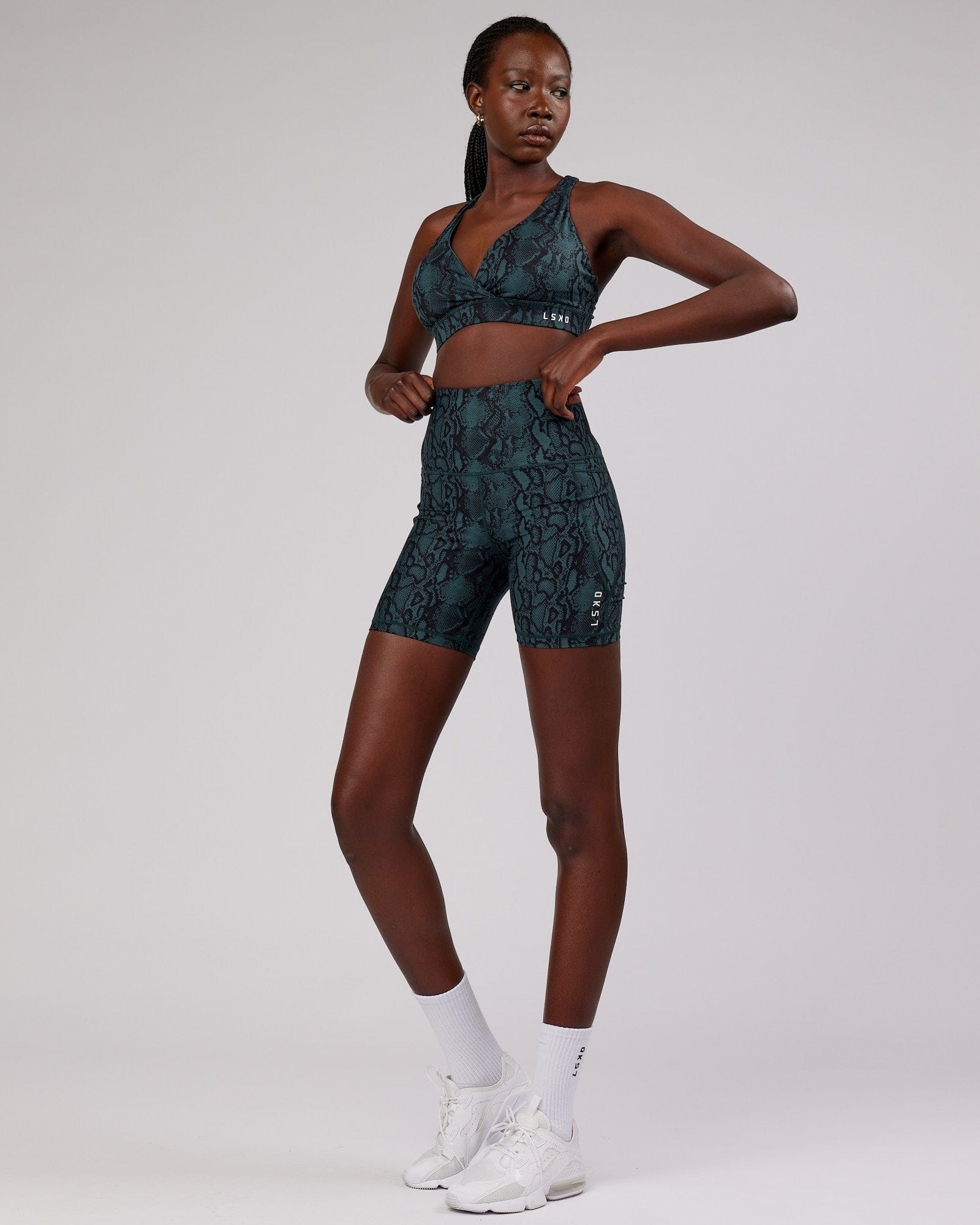 Model wearing Ignite Sports Bra - Forest Snakeskin