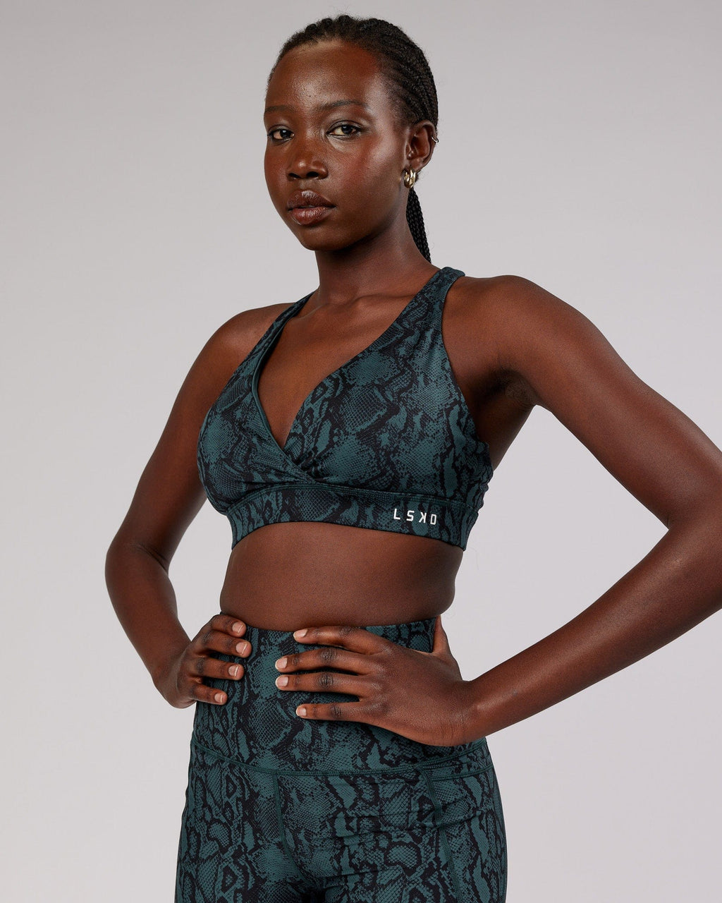 Model wearing Ignite Sports Bra - Forest Snakeskin
