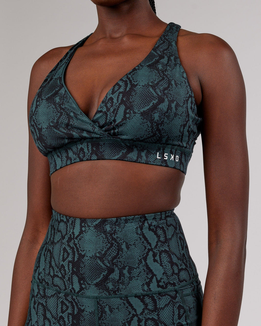Model wearing Ignite Sports Bra - Forest Snakeskin