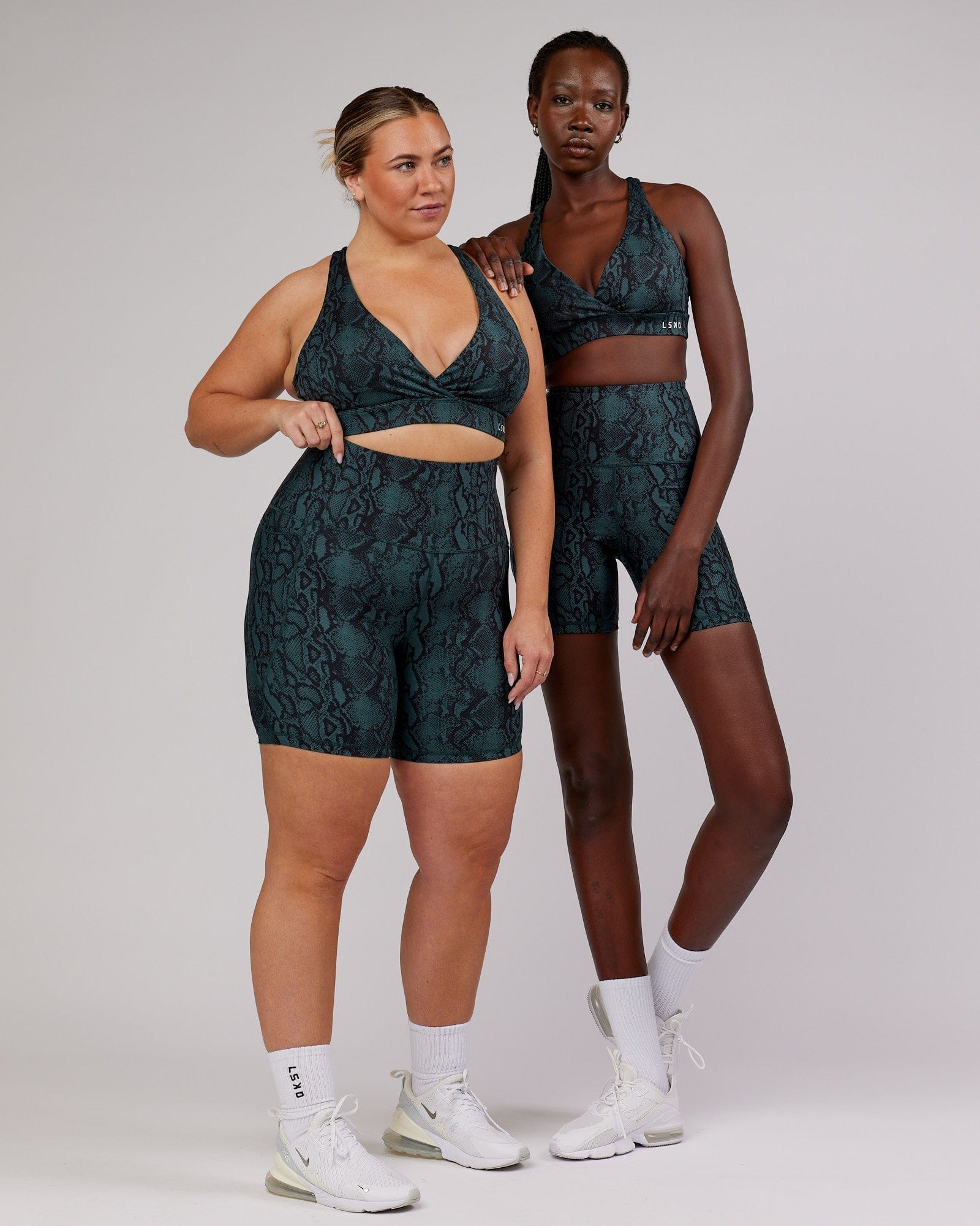 Model wearing Ignite Sports Bra - Forest Snakeskin